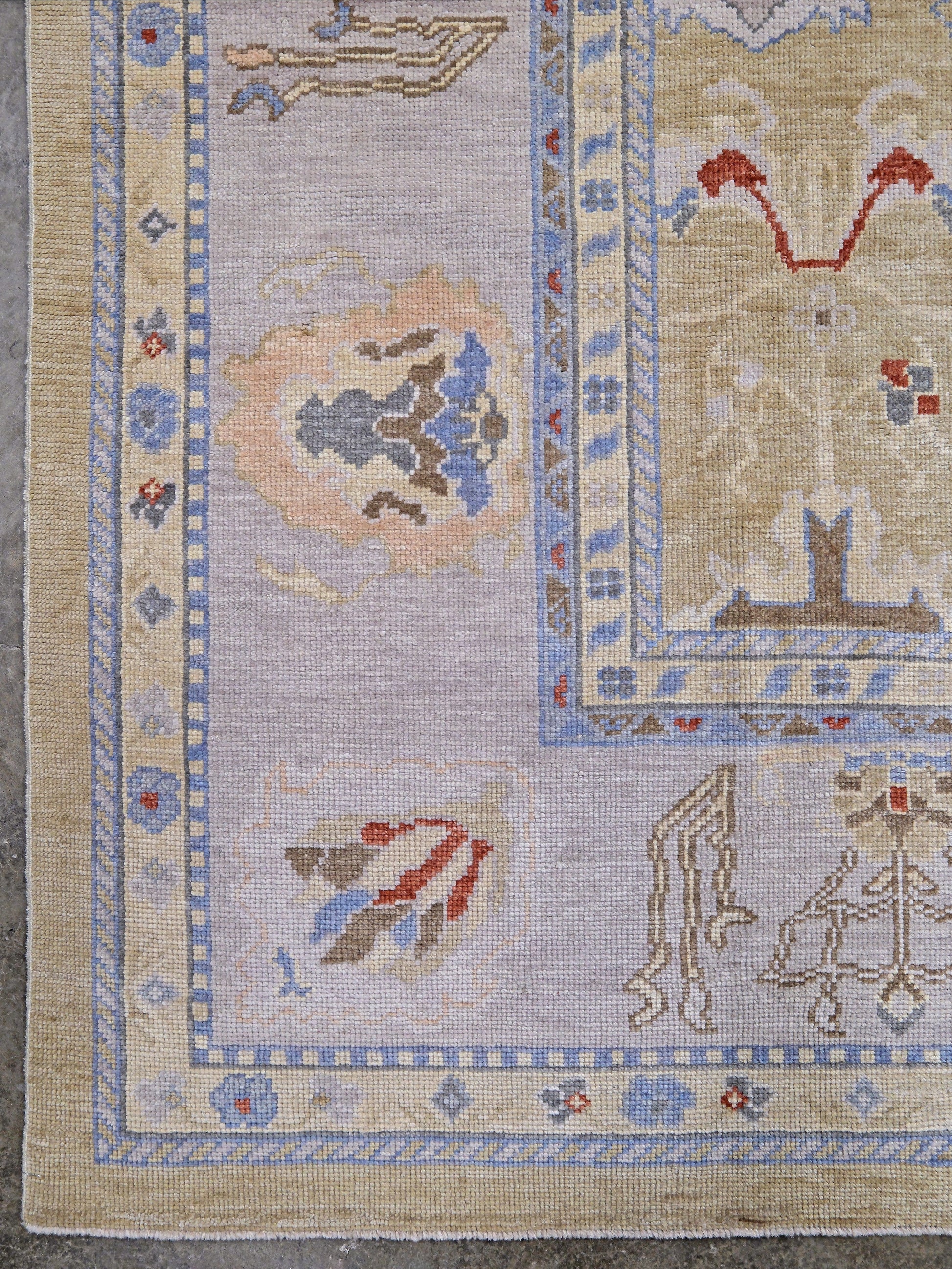 Light olive Turkish Oushak rug with warm ivory border, powder blue floral motifs, soft gray, taupe, and rust accents, hand-knotted wool 10x14 area rug from Indigo Rugs Burlingame Bay Area.