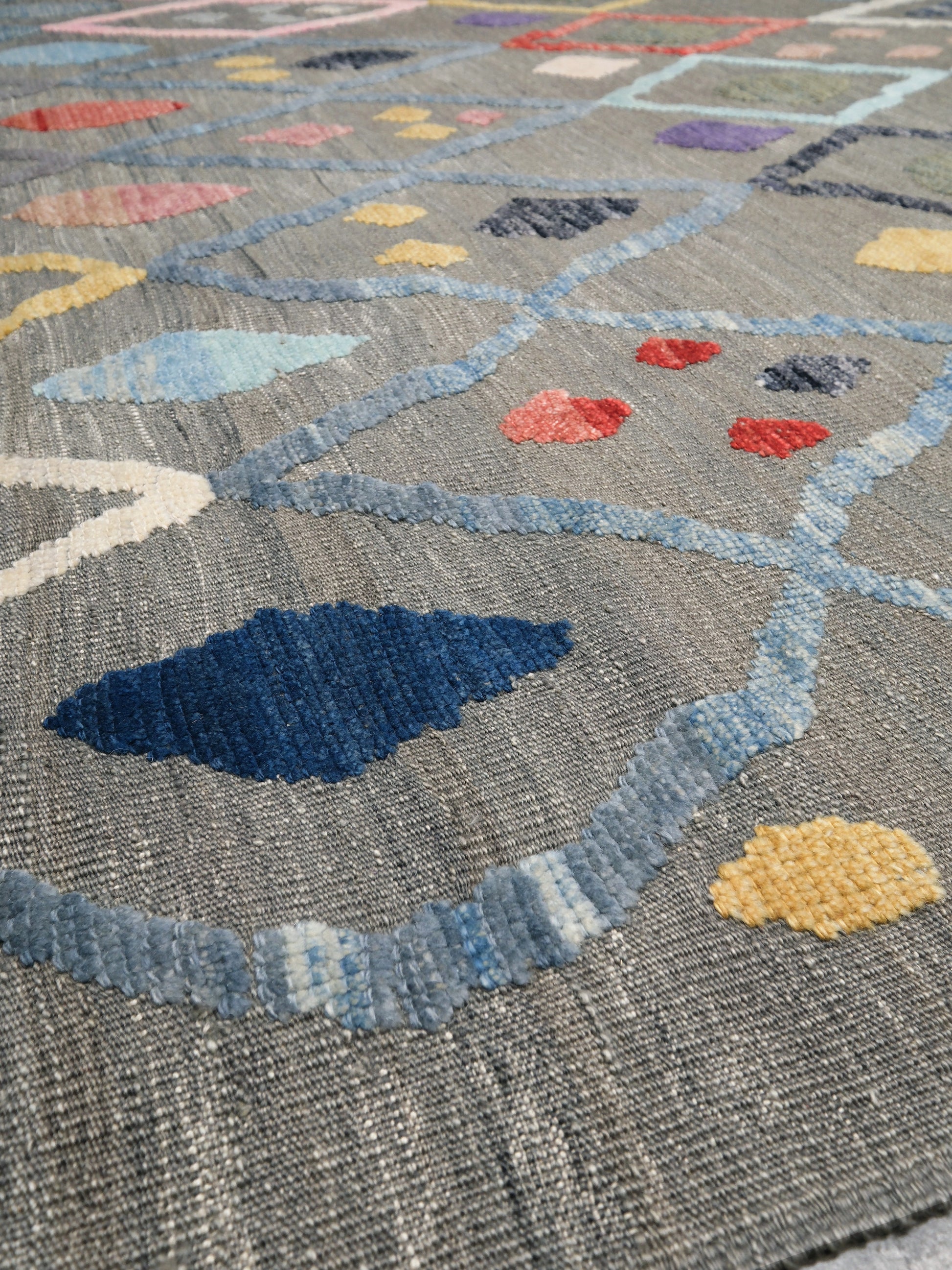 Warm gray vibrant modern Turkish Tulu rug with colorful raised diamond motifs, 3D wool pile texture, handmade wool area rug 9x12 from Indigo Rugs Burlingame Bay Area.