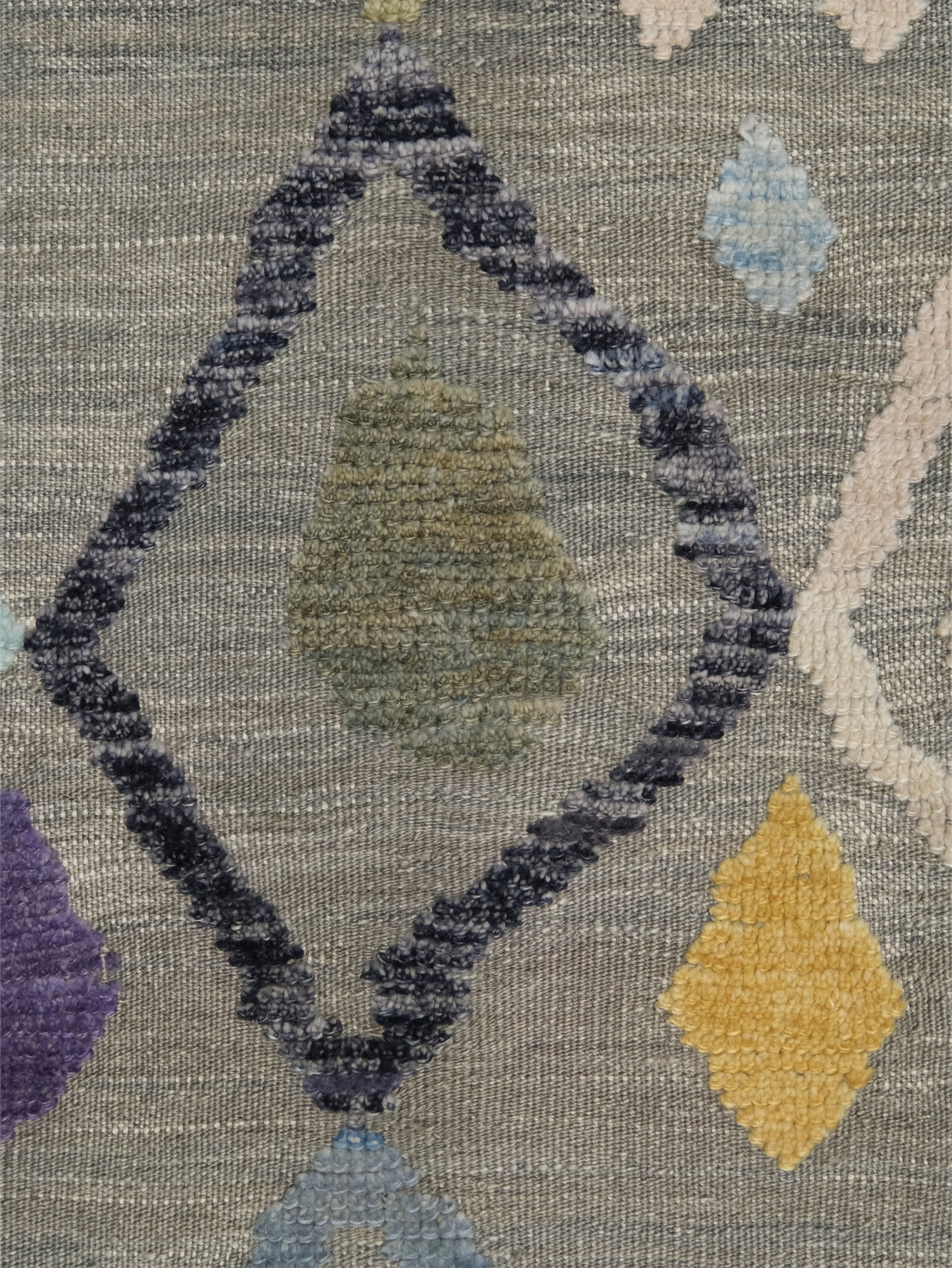 Warm gray vibrant modern Turkish Tulu rug with colorful raised diamond motifs, 3D wool pile texture, handmade wool area rug 9x12 from Indigo Rugs Burlingame Bay Area.