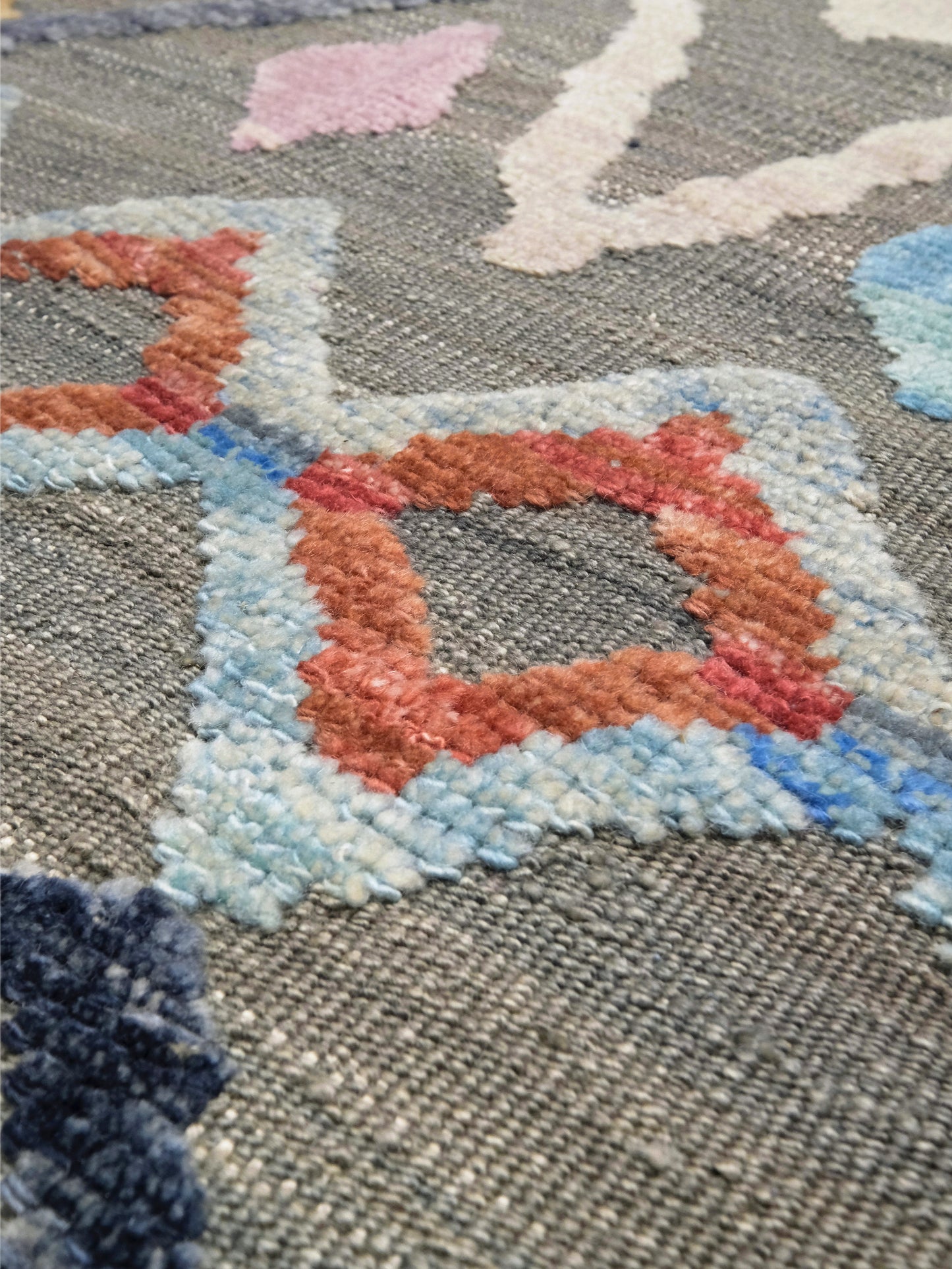 Size:&nbsp;9' x 12'4" (approx. 9 by 12)
Thickness: Roughly 0.35" at the raised wool areas
Rug Type:&nbsp;Modern Tulu / Textured Wool Flatweave Rug
Material: Handmade wool flatweave and raised wool pile&nbsp;and wool foundation.&nbsp;
Colors: Warm gray (field), soft ivory, pale blue, sky blue, dusty coral, terracotta, blush pink, muted yellow, olive green, lavender, charcoal, navy, red and purple accents
Origin: Turkey
Condition:&nbsp;Brand new. Clean and ready to enjoy.