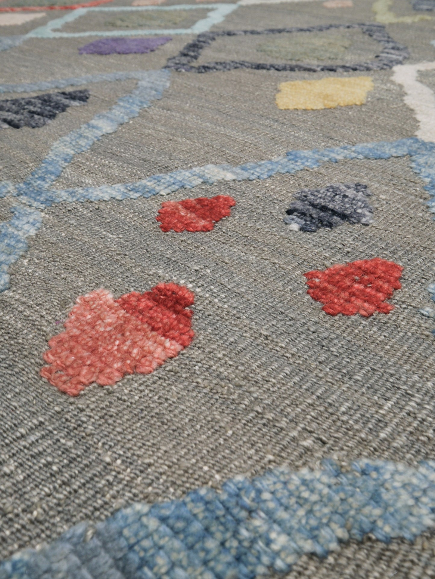 Warm gray vibrant modern Turkish Tulu rug with colorful raised diamond motifs, 3D wool pile texture, handmade wool area rug 9x12 from Indigo Rugs Burlingame Bay Area.