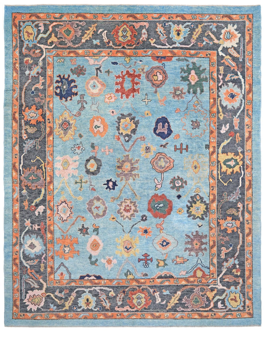 Pale turquoise Turkish Oushak rug with charcoal border, coral orange framing, and colorful abstract floral motifs, hand-knotted wool 8x10 area rug from Indigo Rugs Burlingame Bay Area.