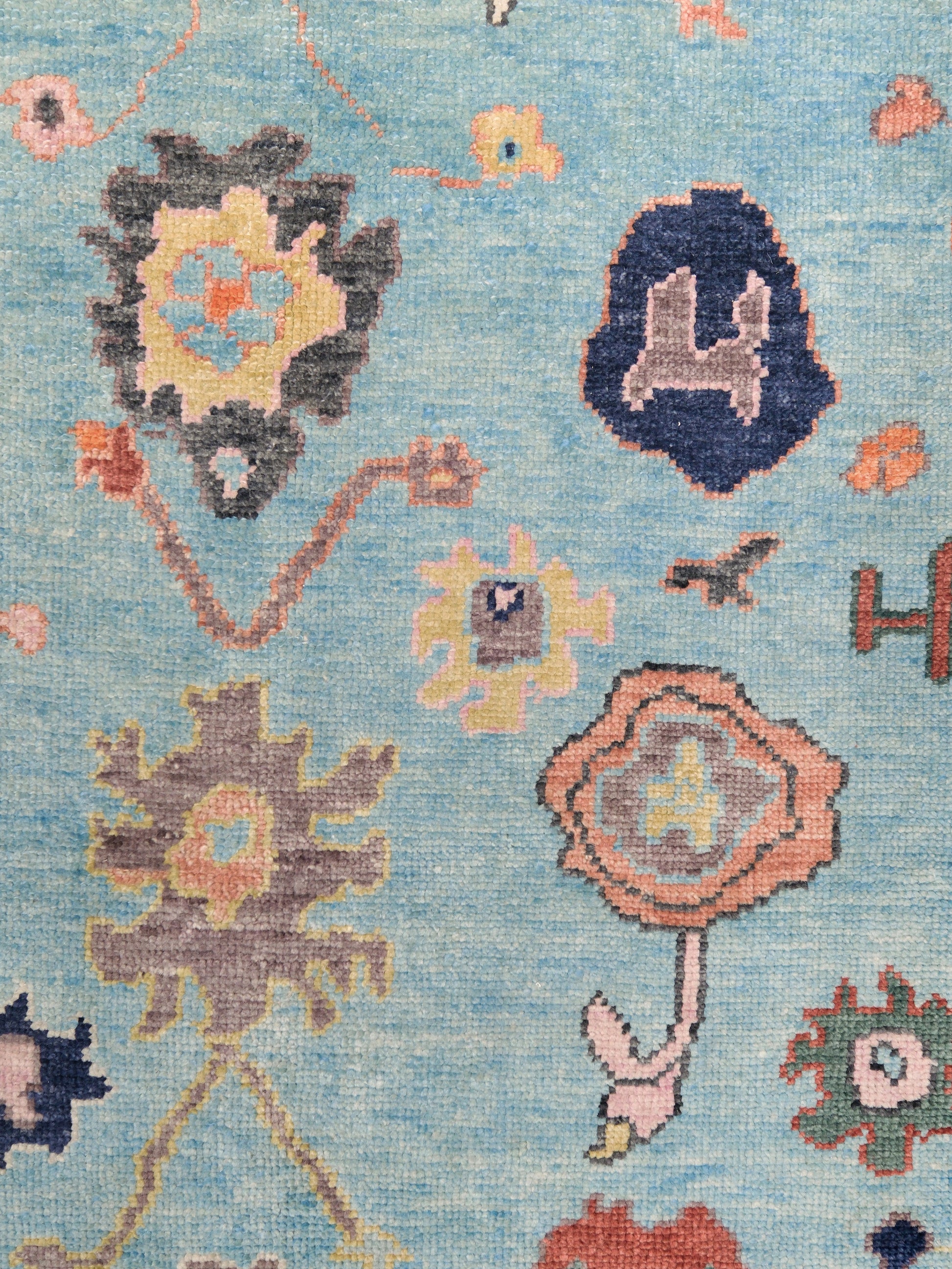 Pale turquoise Turkish Oushak rug with charcoal border, coral orange framing, and colorful abstract floral motifs, hand-knotted wool 8x10 area rug from Indigo Rugs Burlingame Bay Area.