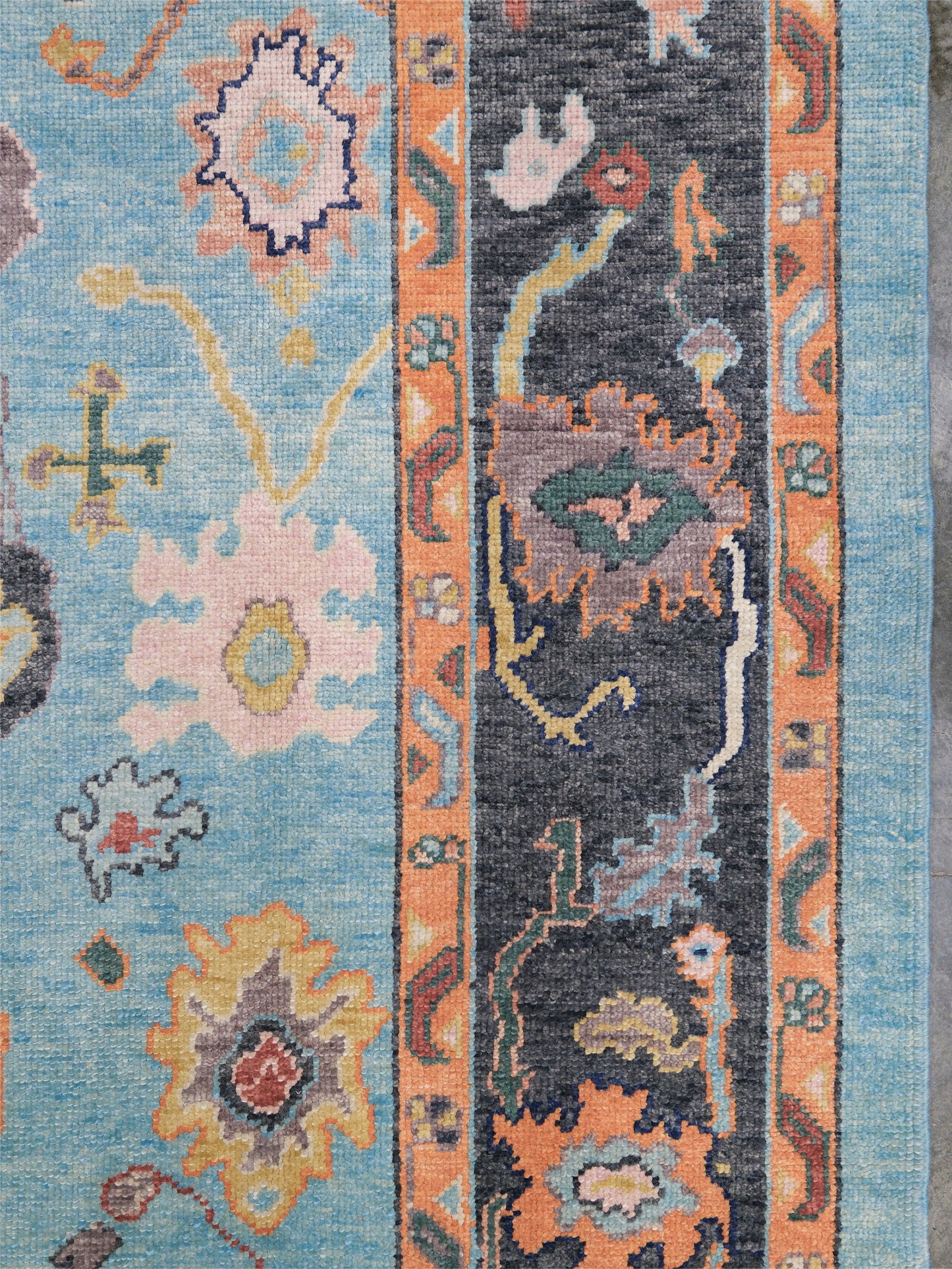 Pale turquoise Turkish Oushak rug with charcoal border, coral orange framing, and colorful abstract floral motifs, hand-knotted wool 8x10 area rug from Indigo Rugs Burlingame Bay Area.