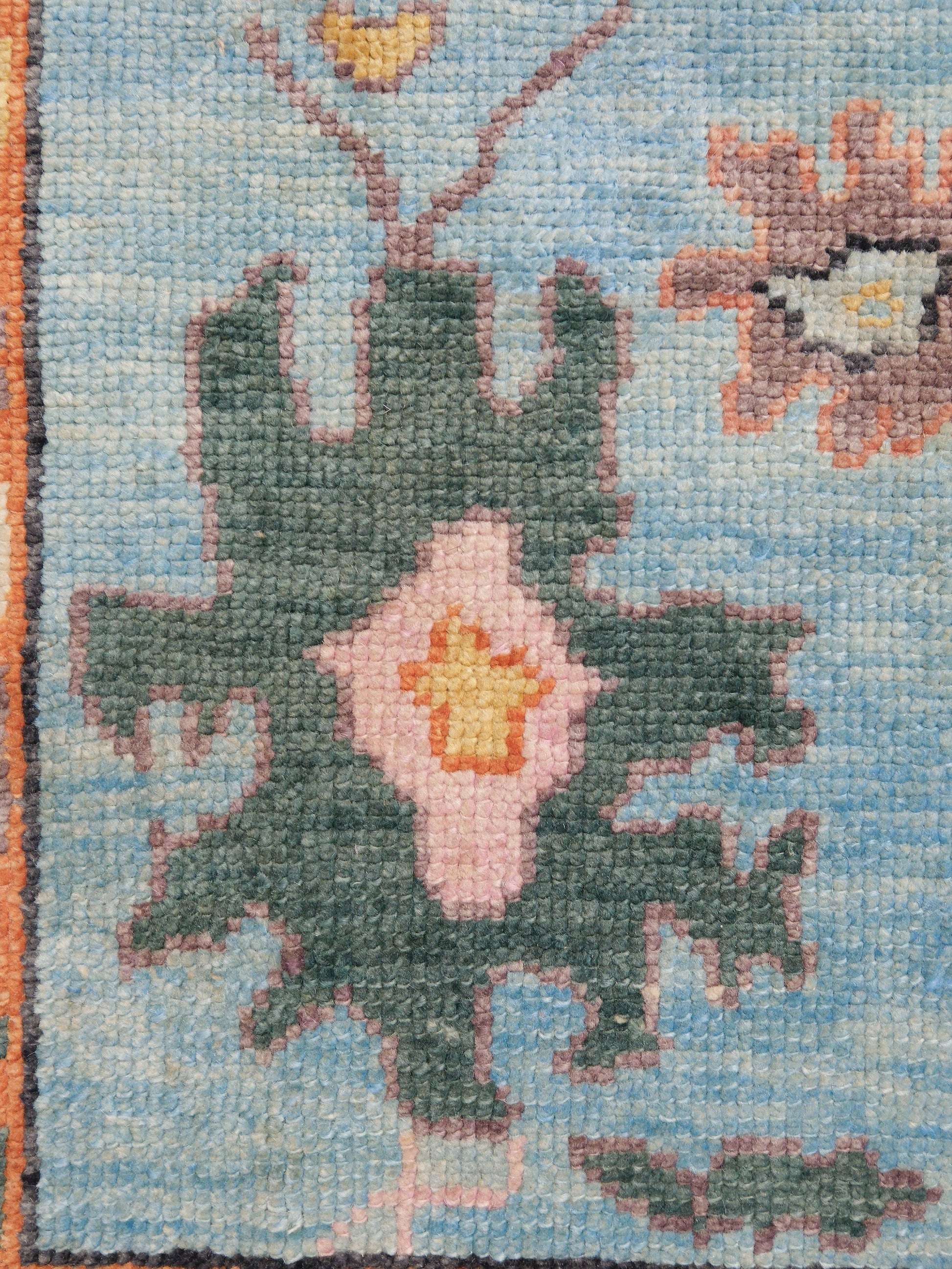 Pale turquoise Turkish Oushak rug with charcoal border, coral orange framing, and colorful abstract floral motifs, hand-knotted wool 8x10 area rug from Indigo Rugs Burlingame Bay Area.