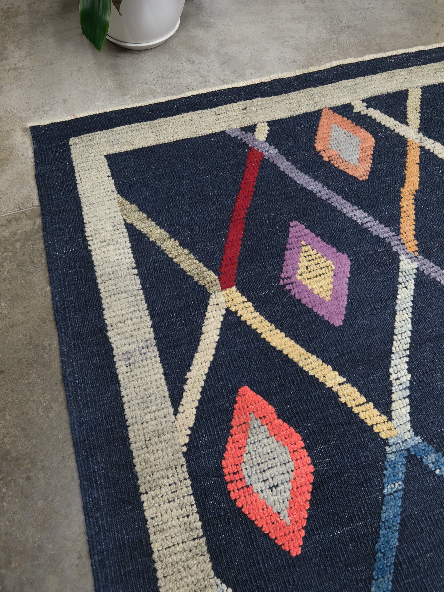 Close-up of Modern Vibrant Turkish Tulu handmade wool a geometric patterned area rug 9x12 from Indigo Rugs Burlingame Bay Area.