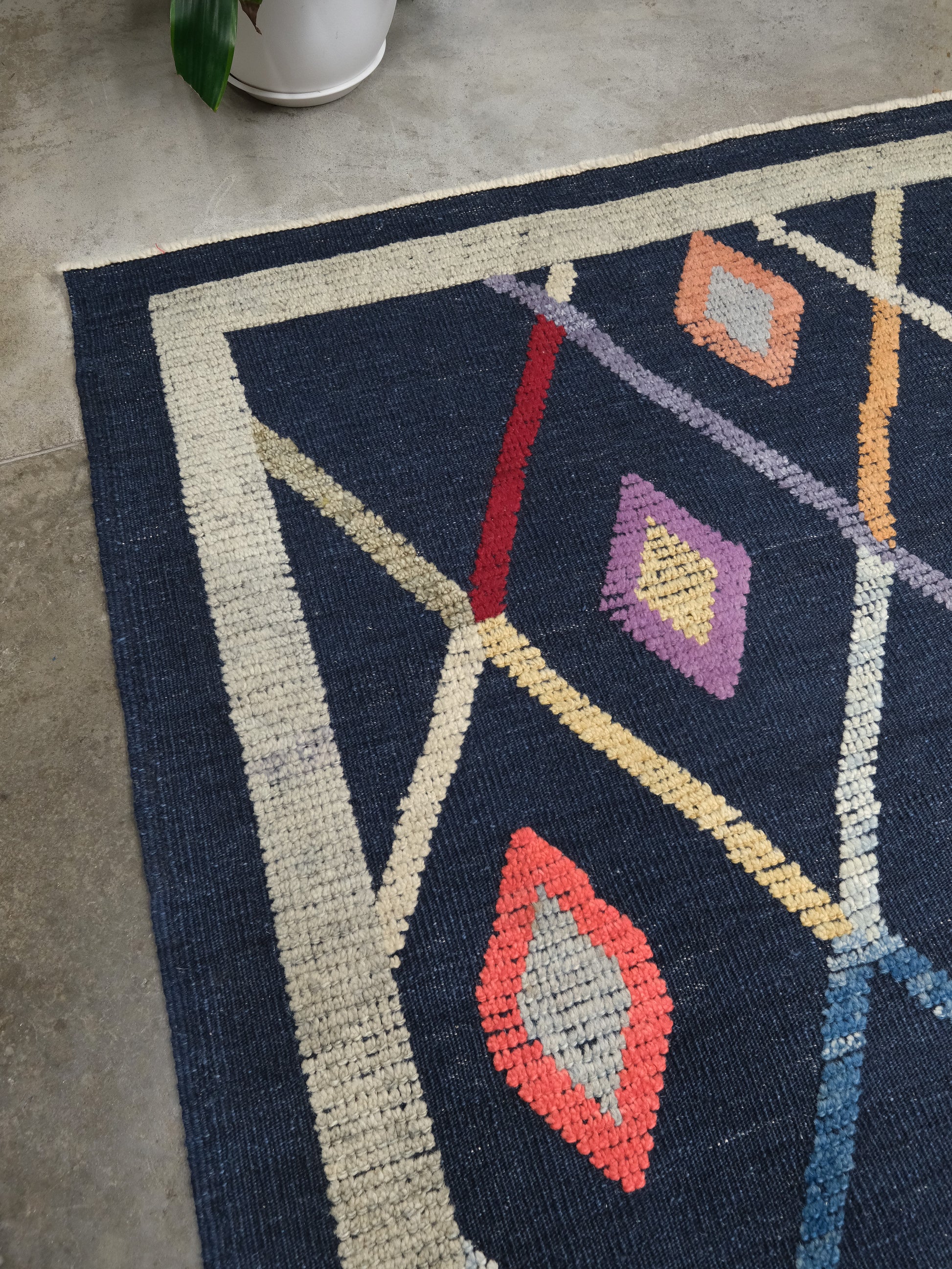 Close-up of Modern Vibrant Turkish Tulu handmade wool a geometric patterned area rug 9x12 from Indigo Rugs Burlingame Bay Area.
