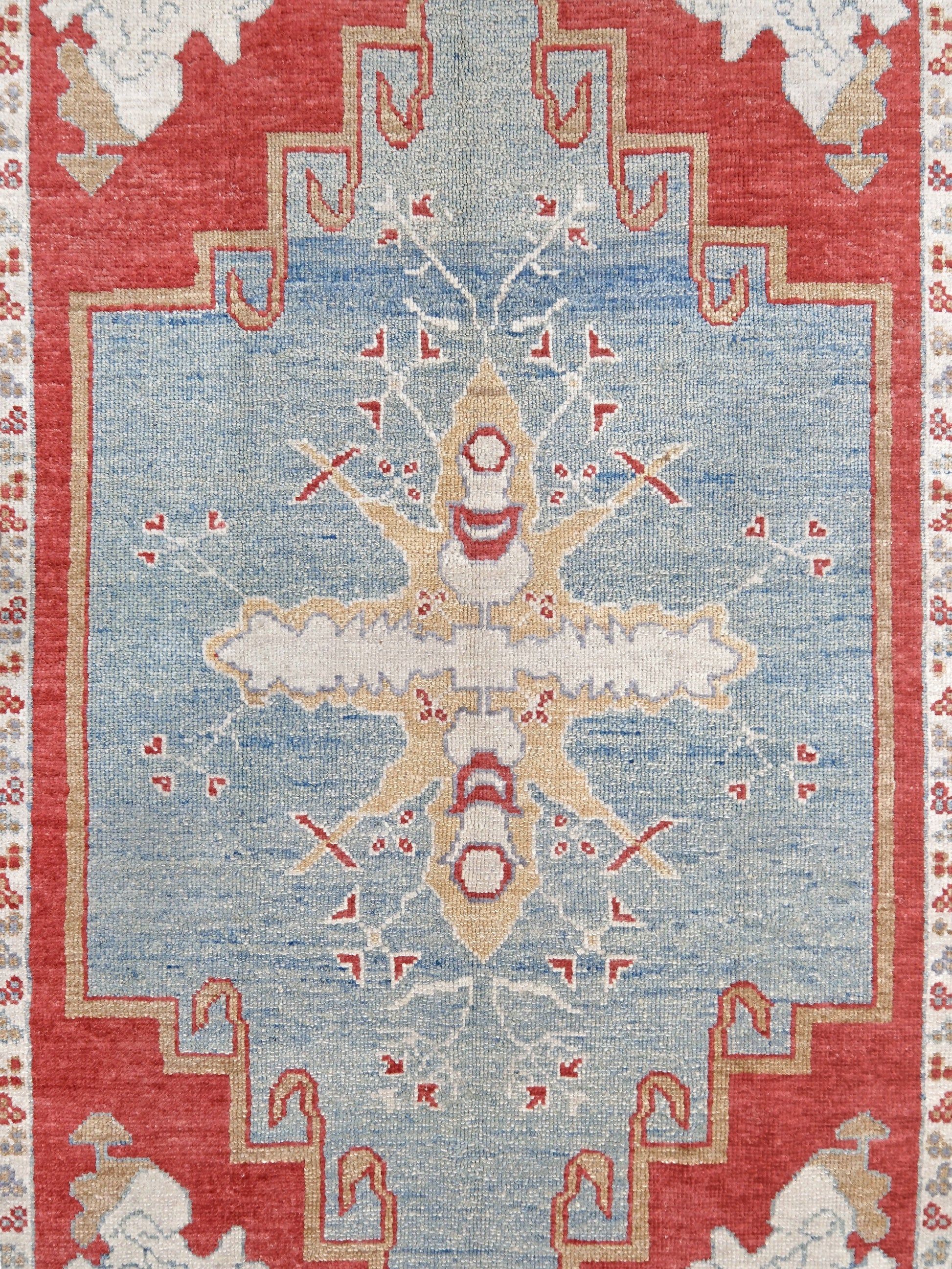 Vibrant soft sky blue and coral red 7x10 Turkish Oushak rug with central medallion, golden beige border, floral motifs and warm ivory accents, handmade wool from Indigo Rugs Burlingame Bay Area.