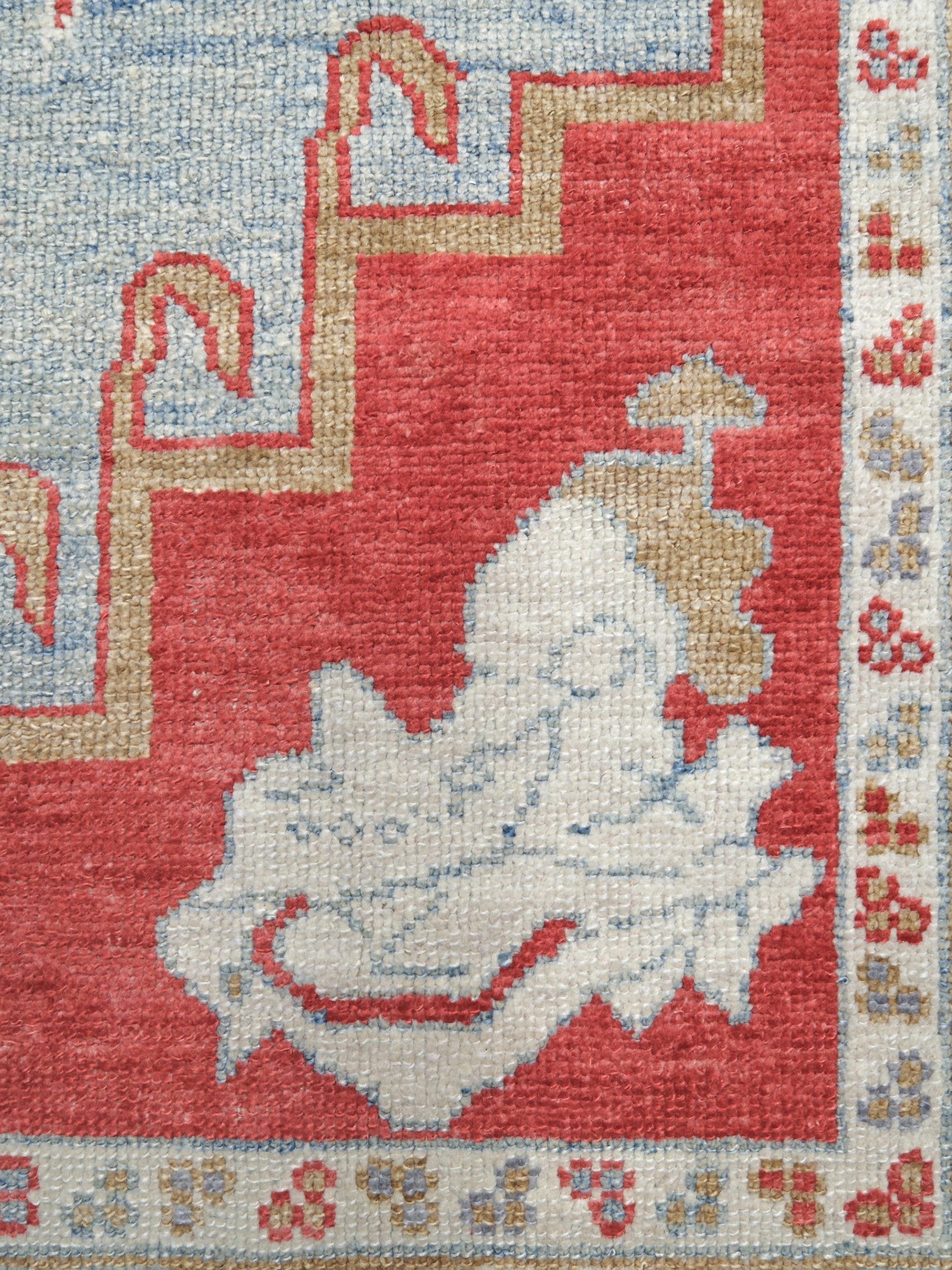 Vibrant soft sky blue and coral red 7x10 Turkish Oushak rug with central medallion, golden beige border, floral motifs and warm ivory accents, handmade wool from Indigo Rugs Burlingame Bay Area.
