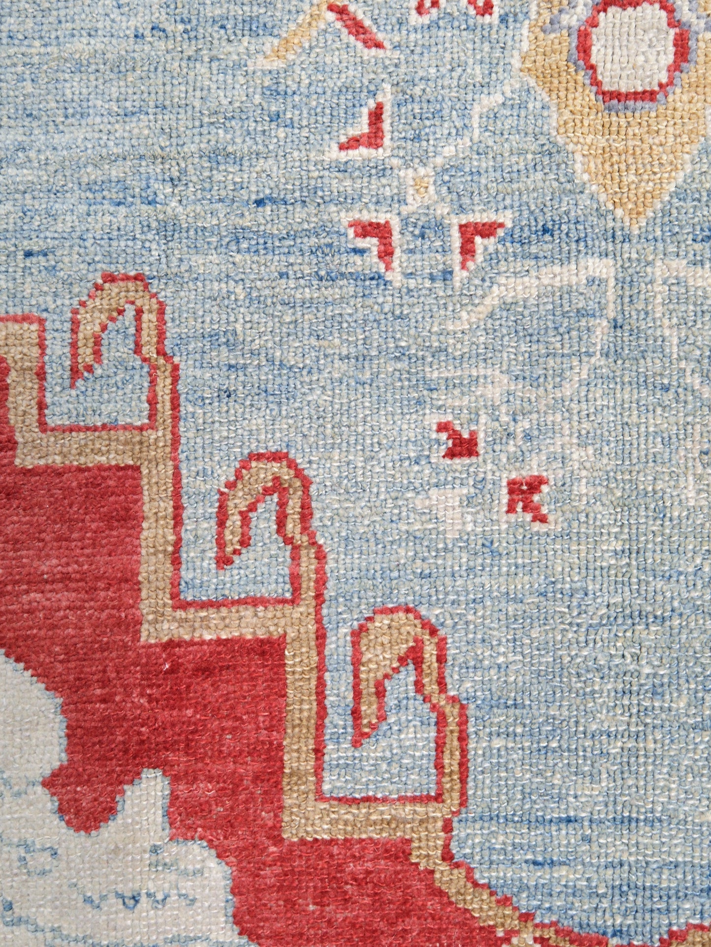Vibrant soft sky blue and coral red 7x10 Turkish Oushak rug with central medallion, golden beige border, floral motifs and warm ivory accents, handmade wool from Indigo Rugs Burlingame Bay Area.