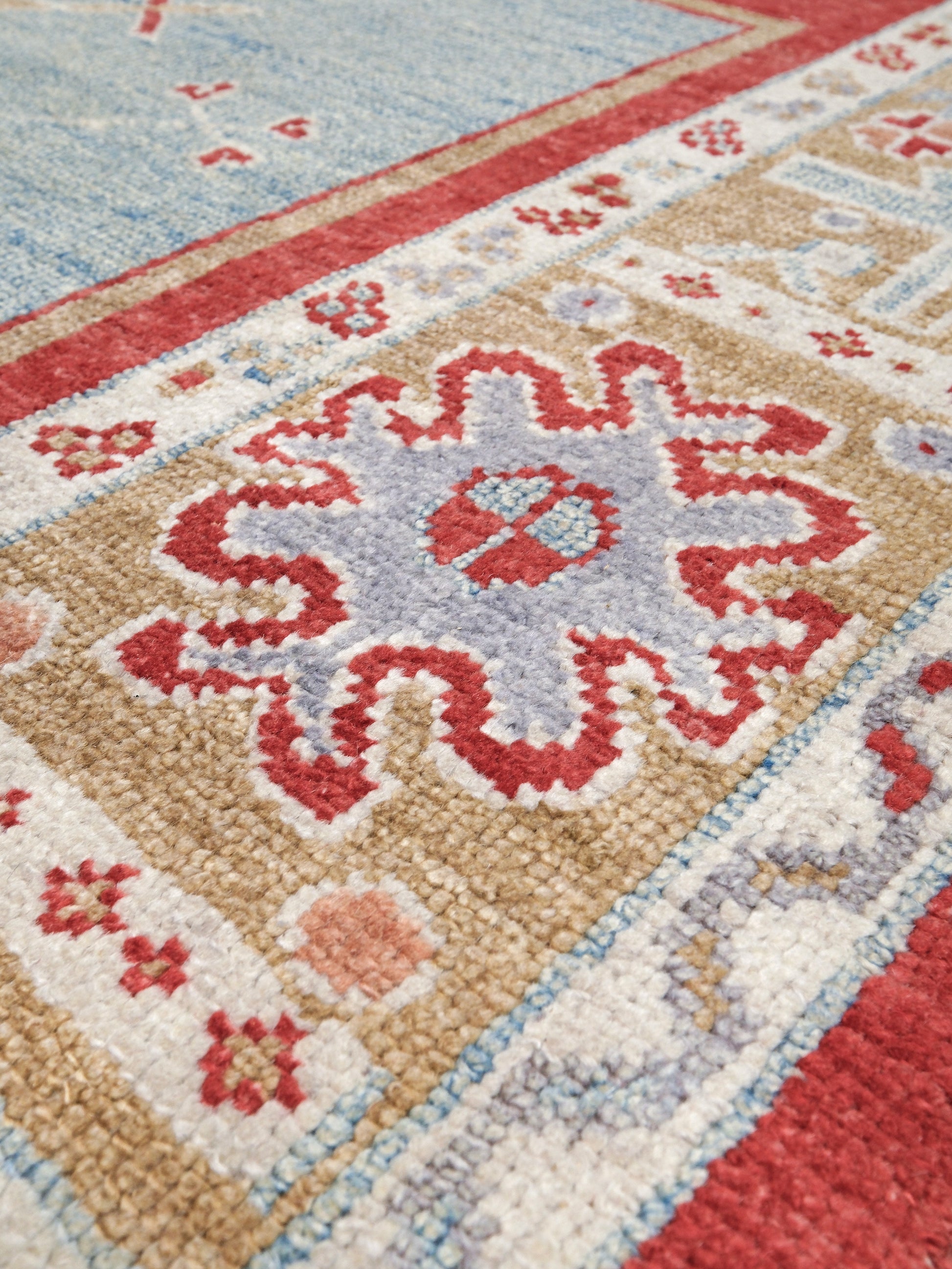 Vibrant soft sky blue and coral red 7x10 Turkish Oushak rug with central medallion, golden beige border, floral motifs and warm ivory accents, handmade wool from Indigo Rugs Burlingame Bay Area.