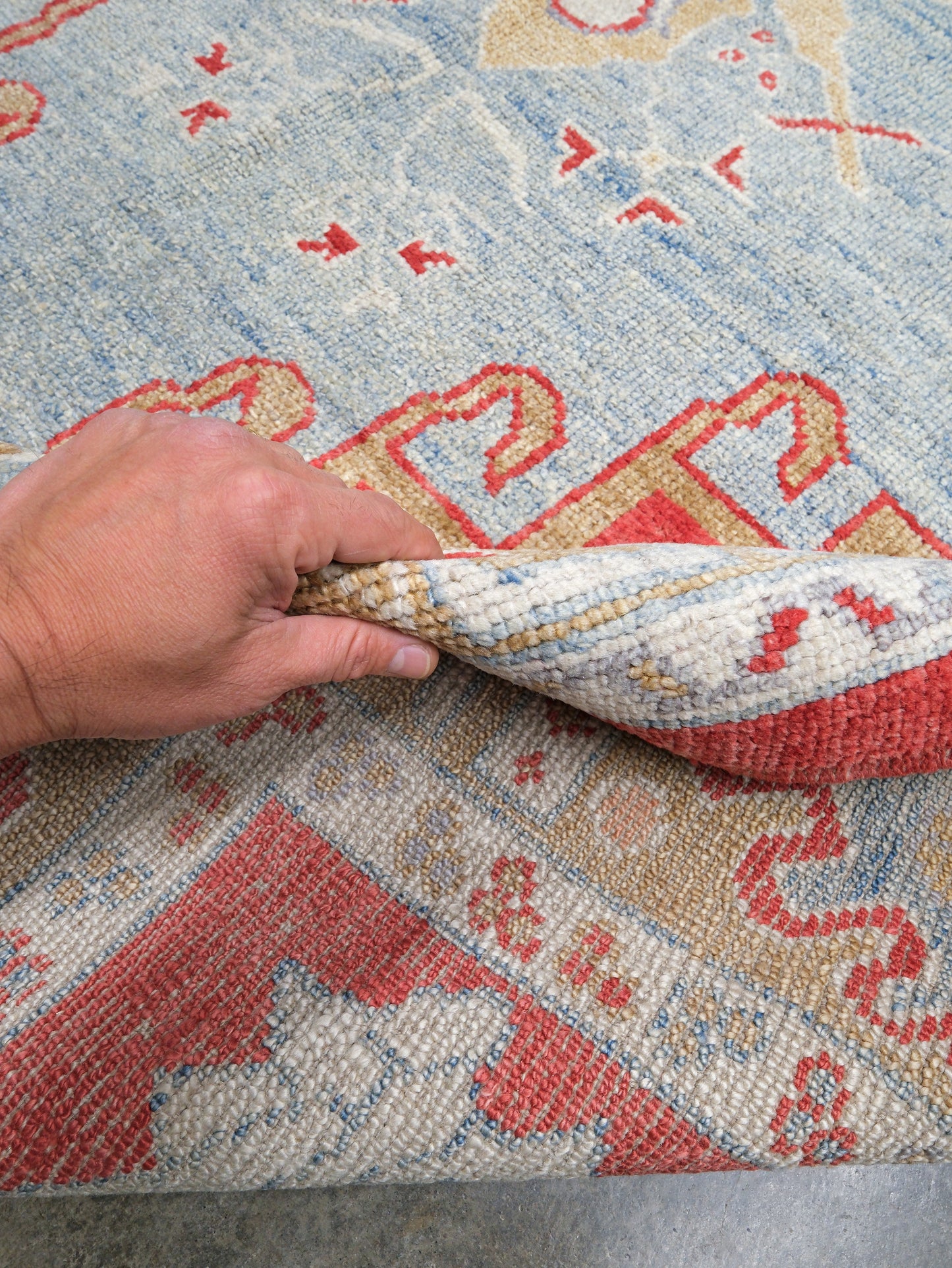 Vibrant soft sky blue and coral red 7x10 Turkish Oushak rug with central medallion, golden beige border, floral motifs and warm ivory accents, handmade wool from Indigo Rugs Burlingame Bay Area.