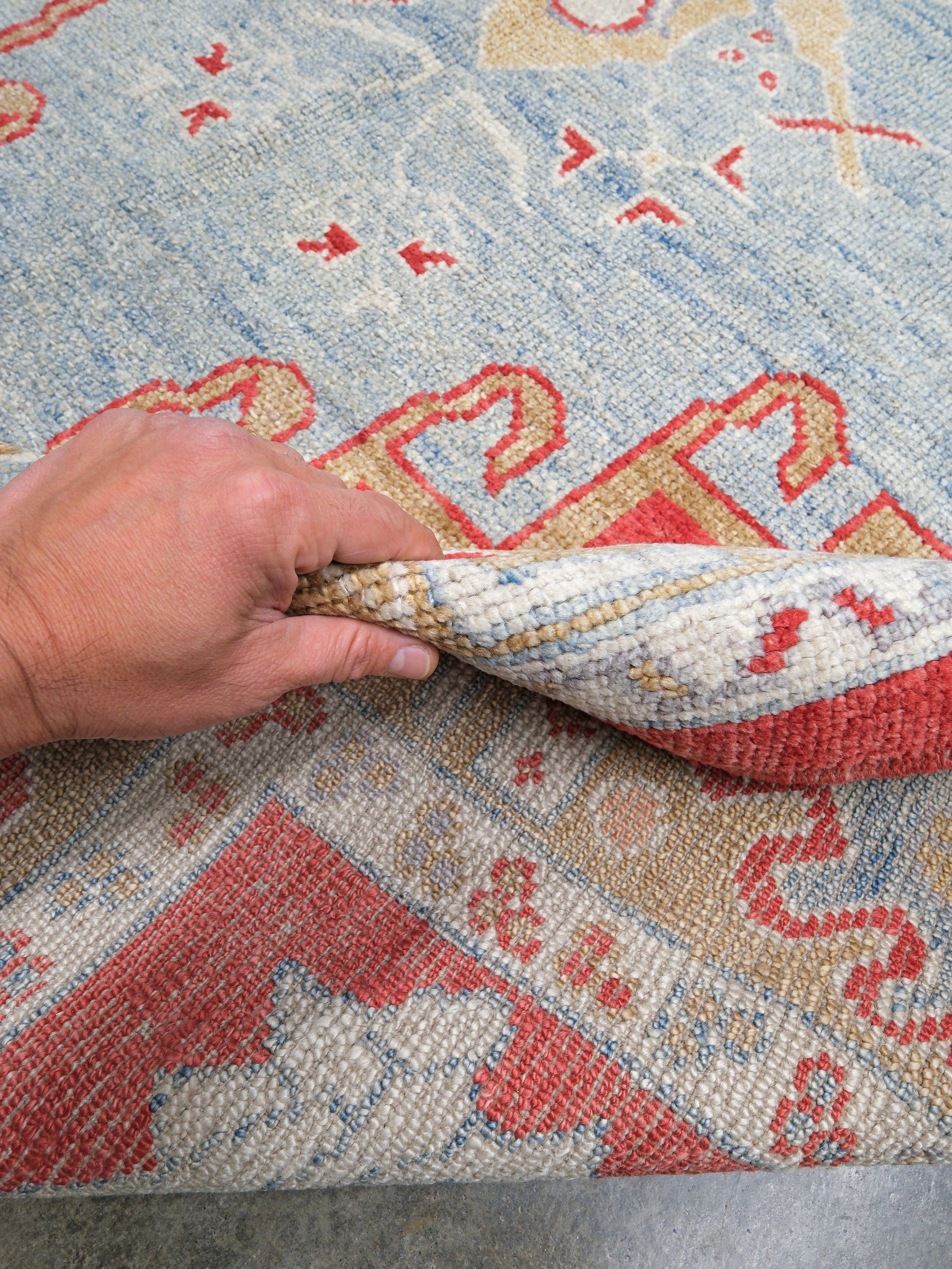 Vibrant soft sky blue and coral red 7x10 Turkish Oushak rug with central medallion, golden beige border, floral motifs and warm ivory accents, handmade wool from Indigo Rugs Burlingame Bay Area.