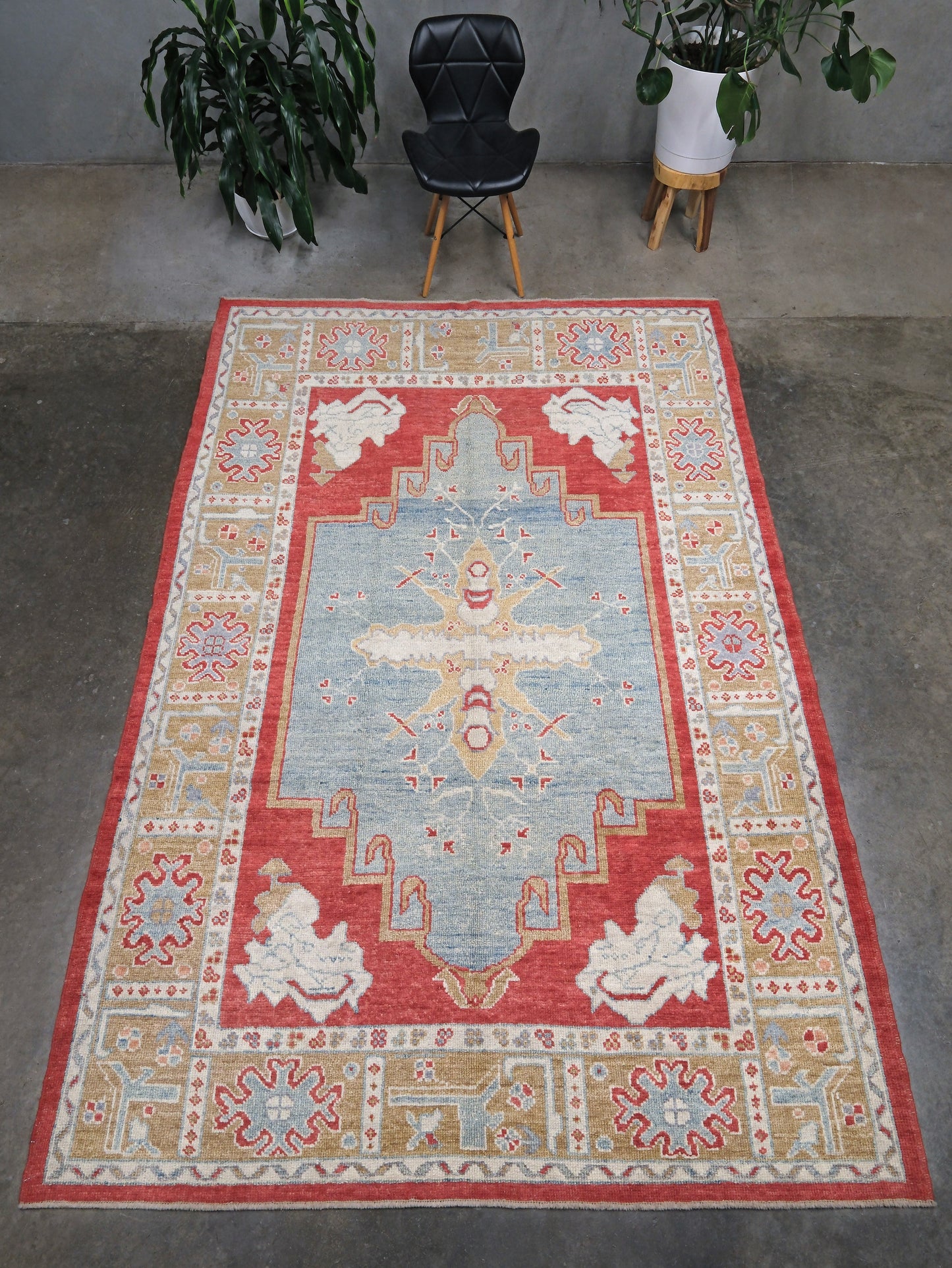 Vibrant soft sky blue and coral 7x10 Turkish Oushak rug with central medallion, golden beige border, floral motifs and warm ivory accents, handmade wool from Indigo Rugs Burlingame Bay Area.