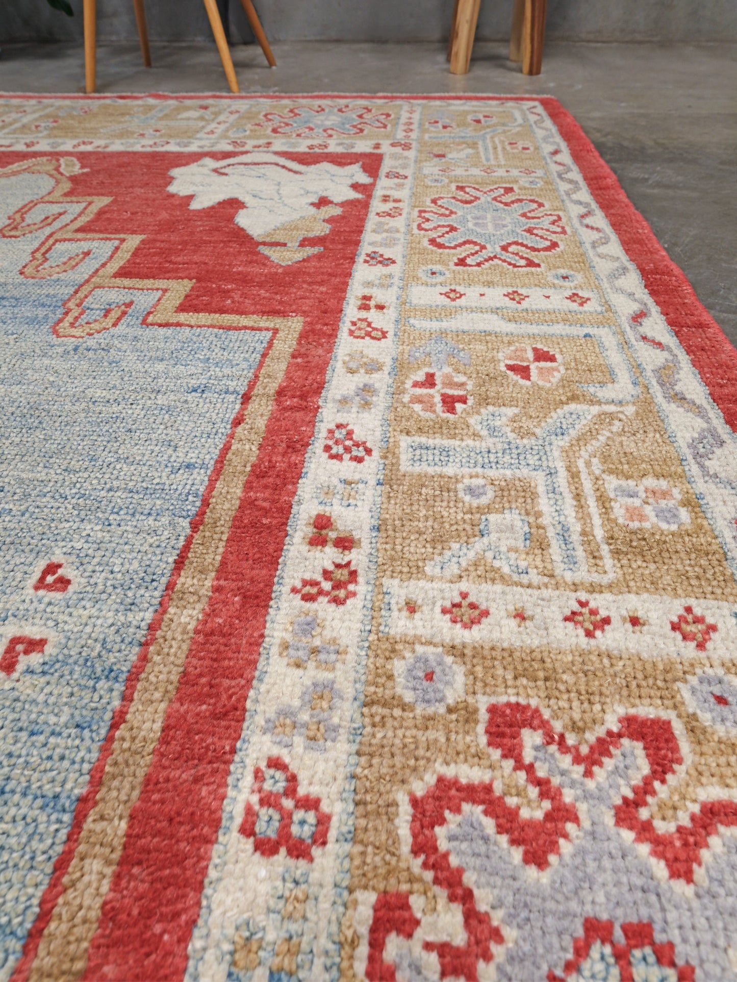 Soft sky blue and coral red 7x10 Turkish Oushak rug with central medallion, golden beige border, floral motifs and warm ivory accents, handmade wool from Indigo Rugs Burlingame Bay Area.