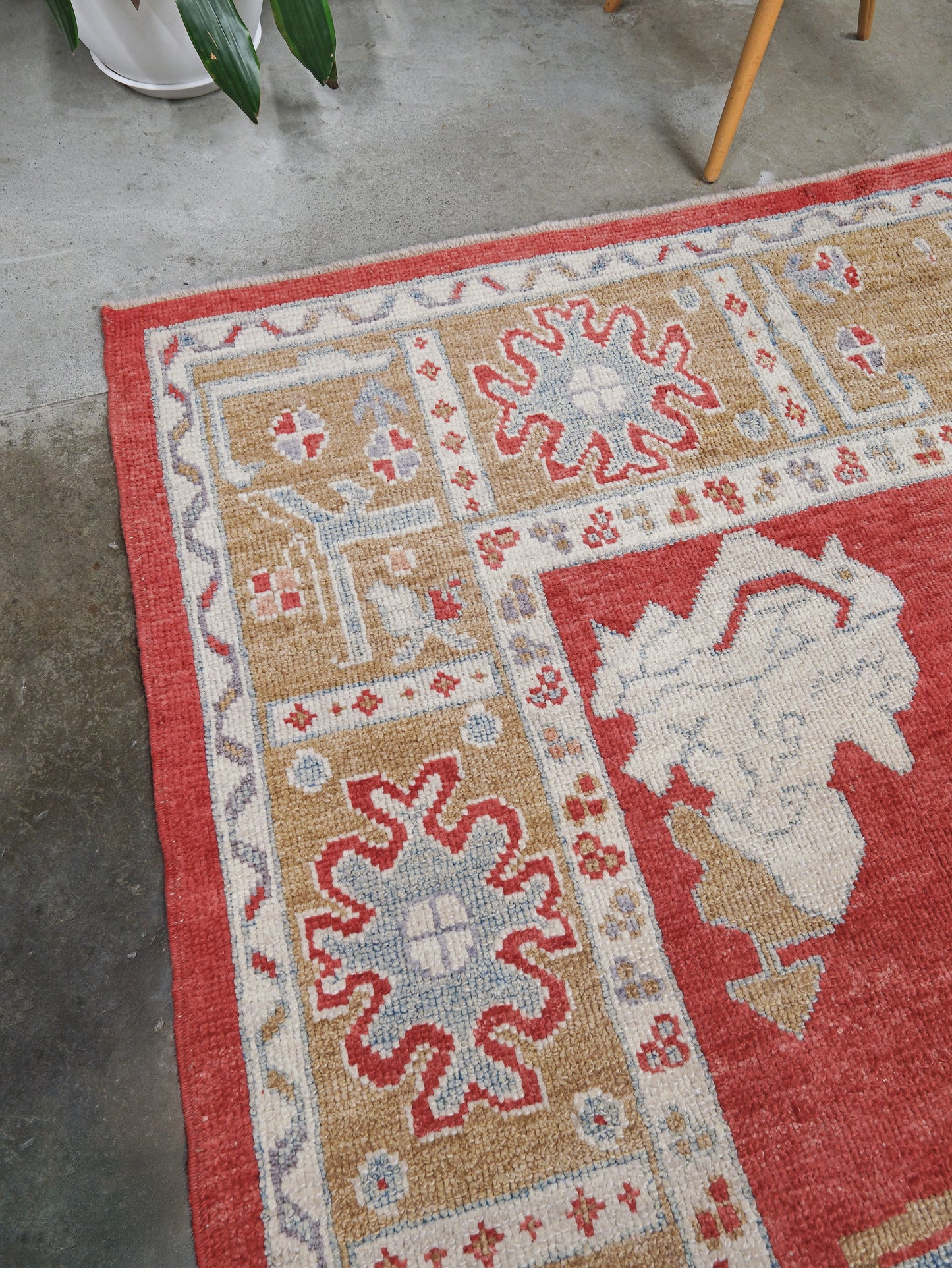 Vibrant soft sky blue and coral 7x10 Turkish Oushak rug with central medallion, golden beige border, floral motifs and warm ivory accents, handmade wool from Indigo Rugs Burlingame Bay Area.
