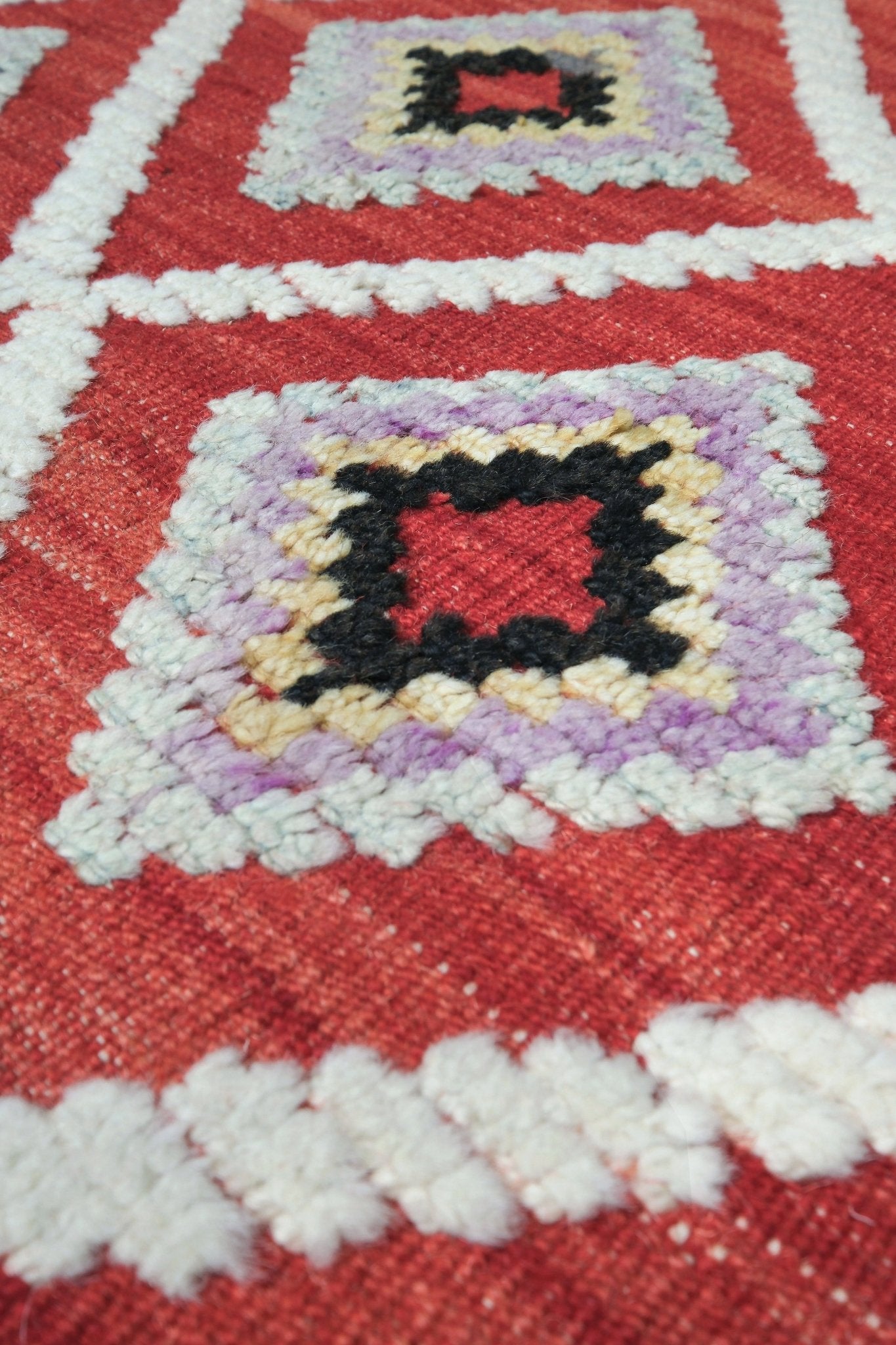 Red Turkish Tulu rug with ivory diamond lattice, raised wool texture, lavender, gray-blue, accents, 6x9 handmade moroccan style area rug from Indigo Rugs Burlingame Bay Area.
