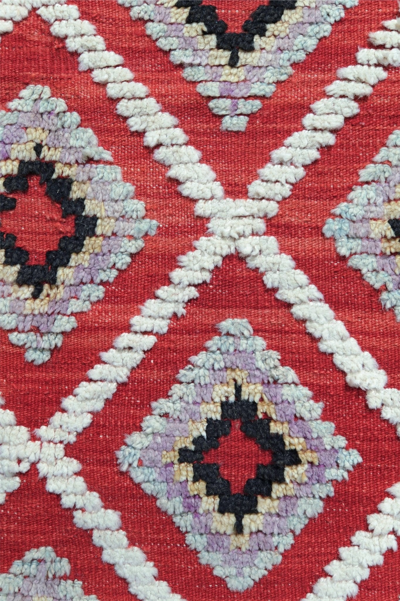 Red Turkish Tulu rug with ivory diamond lattice, raised wool texture, lavender, gray-blue, accents, 6x9 handmade moroccan style area rug from Indigo Rugs Burlingame Bay Area.