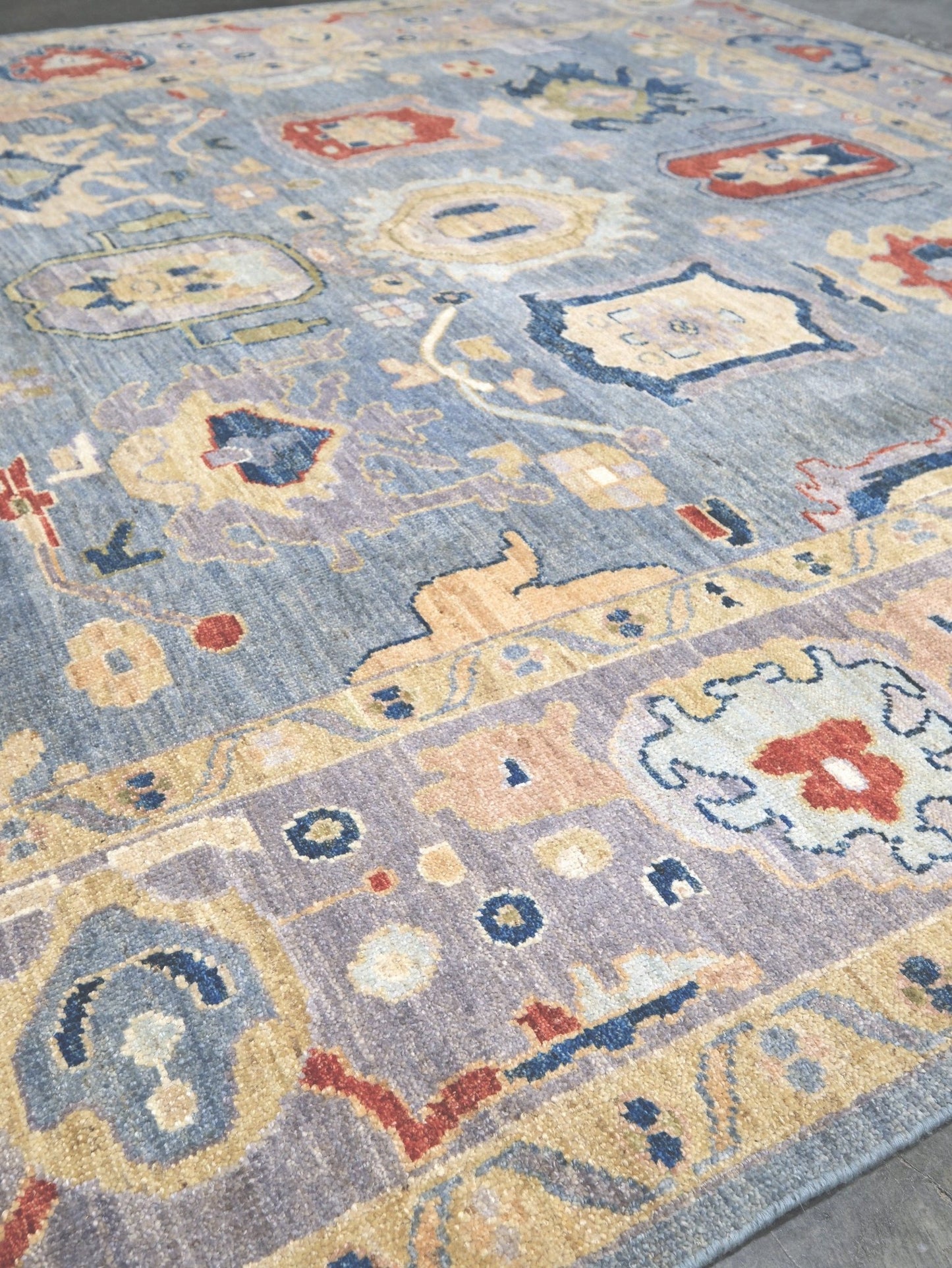 Powder blue Turkish Oushak rug with pale lavender border, warm ivory floral motifs, hand-knotted wool area rug 8x10 from Indigo Rugs Burlingame Bay Area.