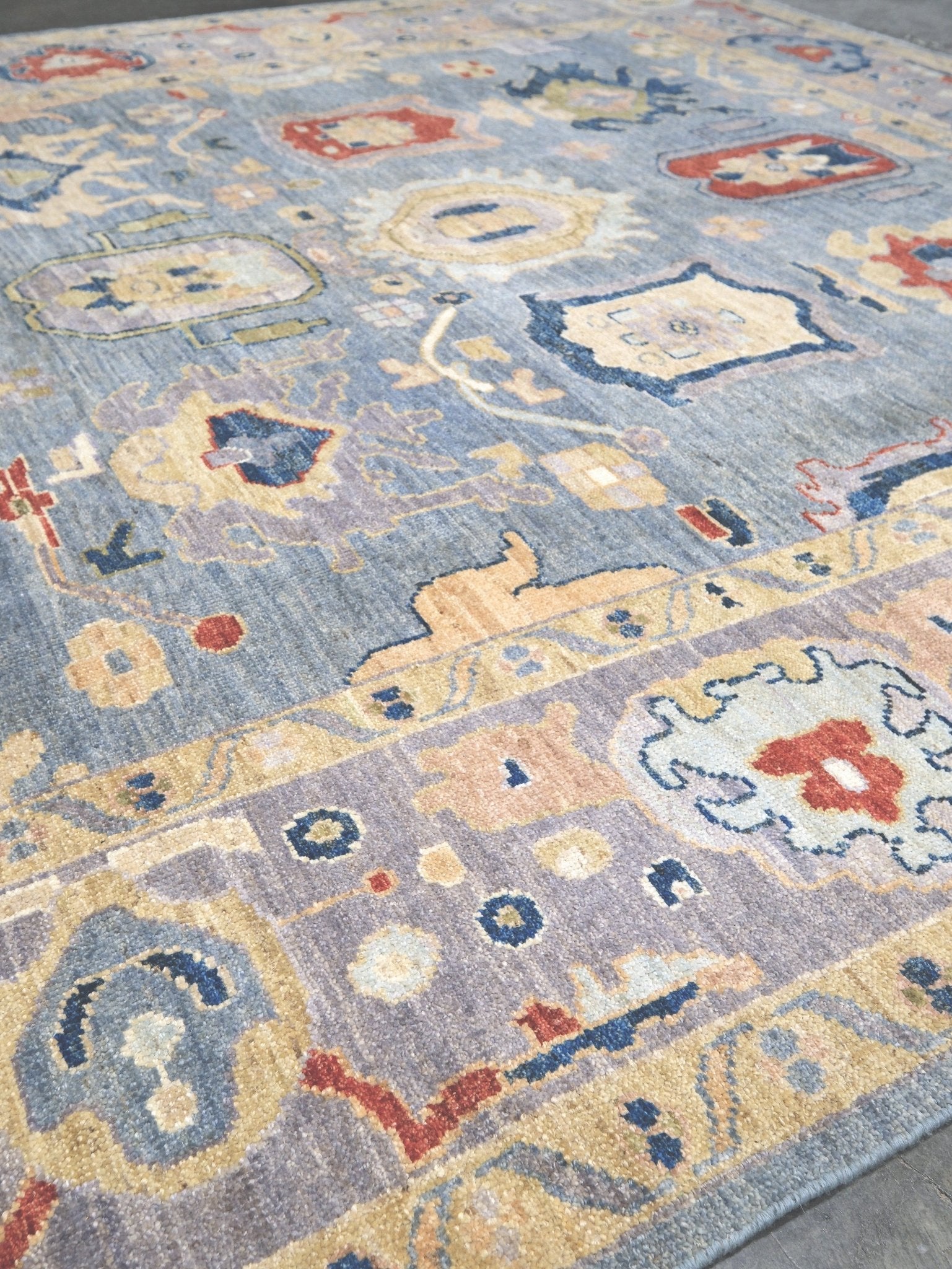 Powder blue Turkish Oushak rug with pale lavender border, warm ivory floral motifs, hand-knotted wool area rug 8x10 from Indigo Rugs Burlingame Bay Area.