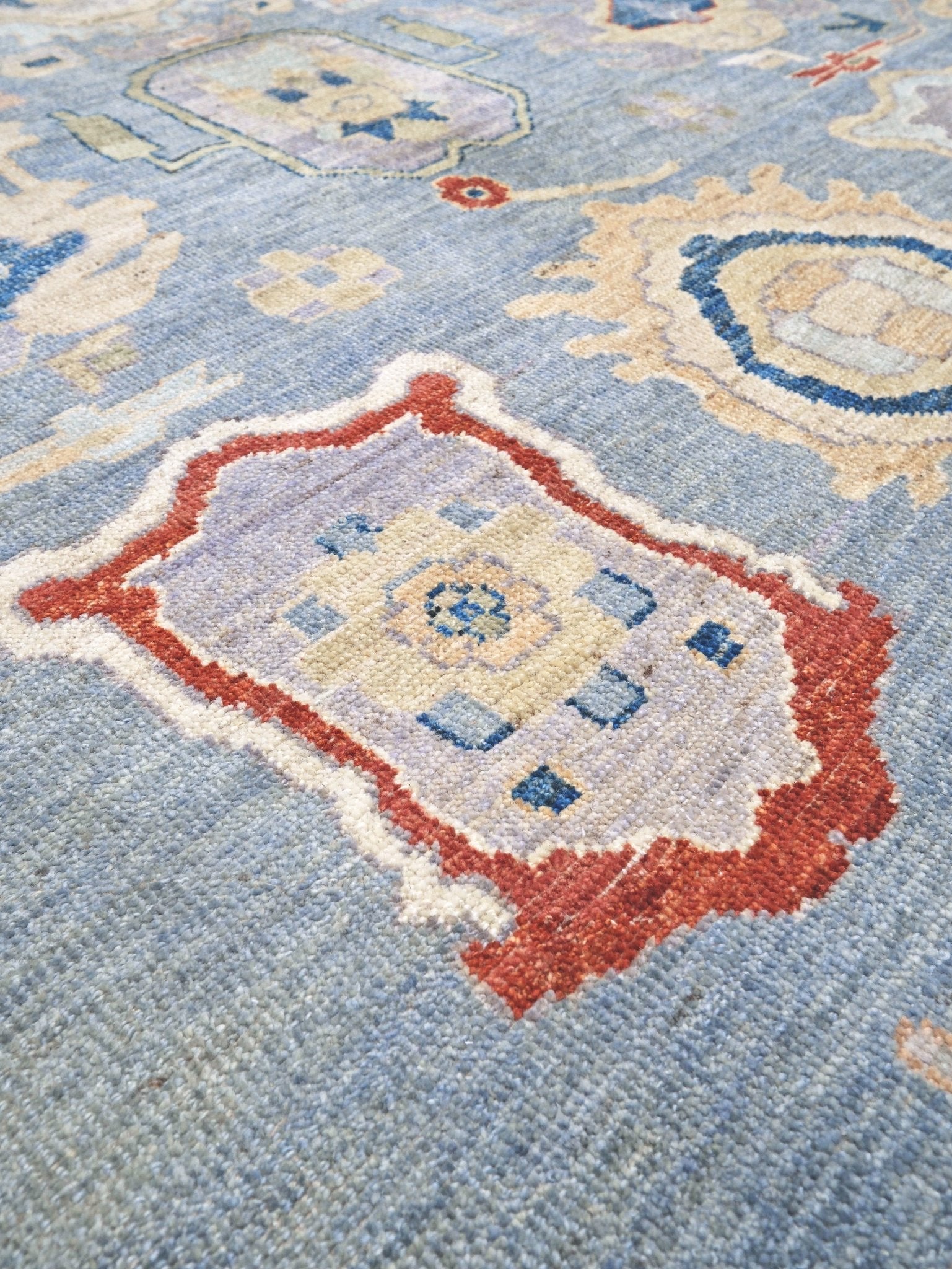 Powder blue Turkish Oushak rug with pale lavender border, warm ivory floral motifs, hand-knotted wool area rug 8x10 from Indigo Rugs Burlingame Bay Area.