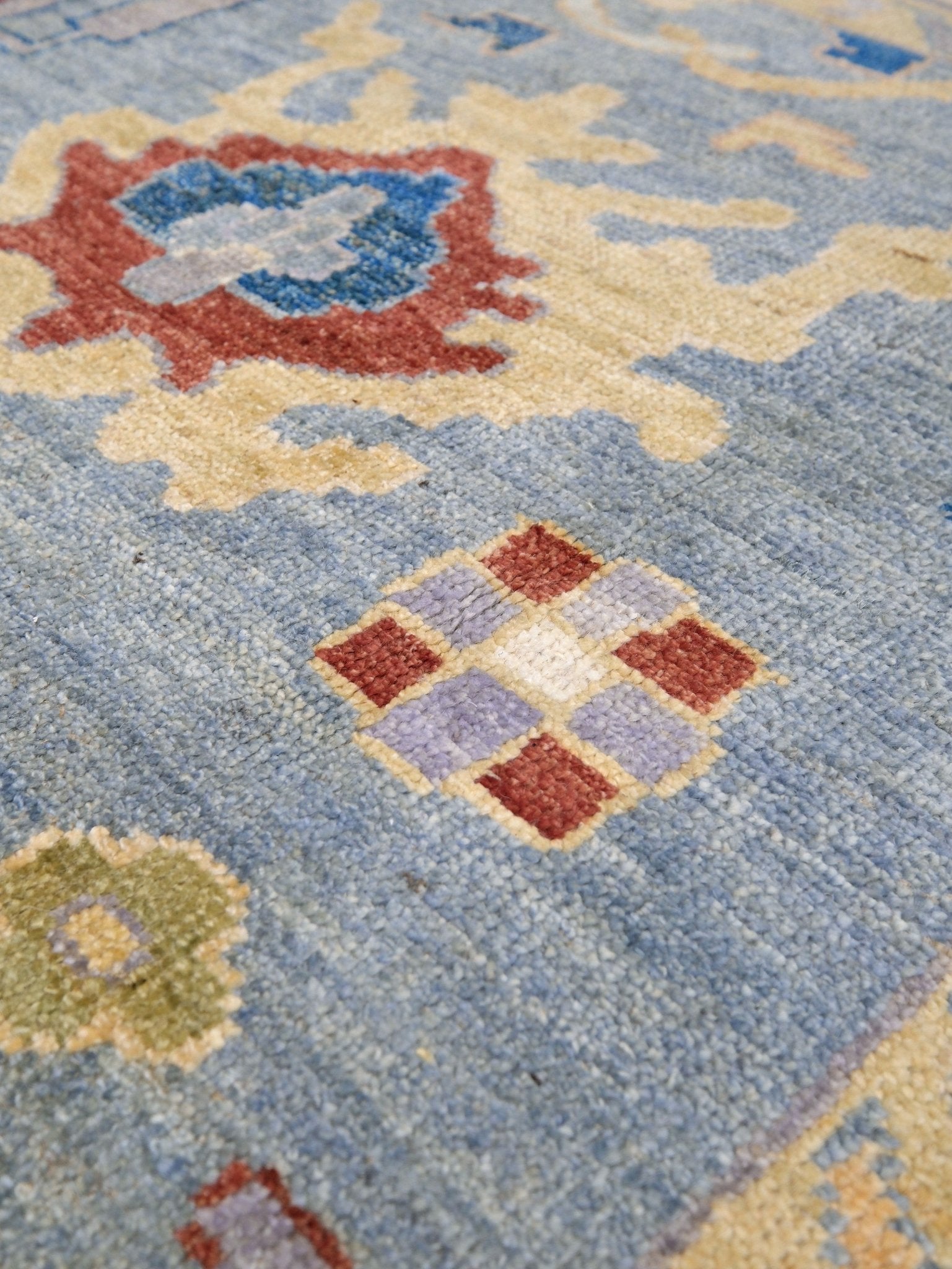 Powder blue Turkish Oushak rug with pale lavender border, warm ivory floral motifs, hand-knotted wool area rug 8x10 from Indigo Rugs Burlingame Bay Area.