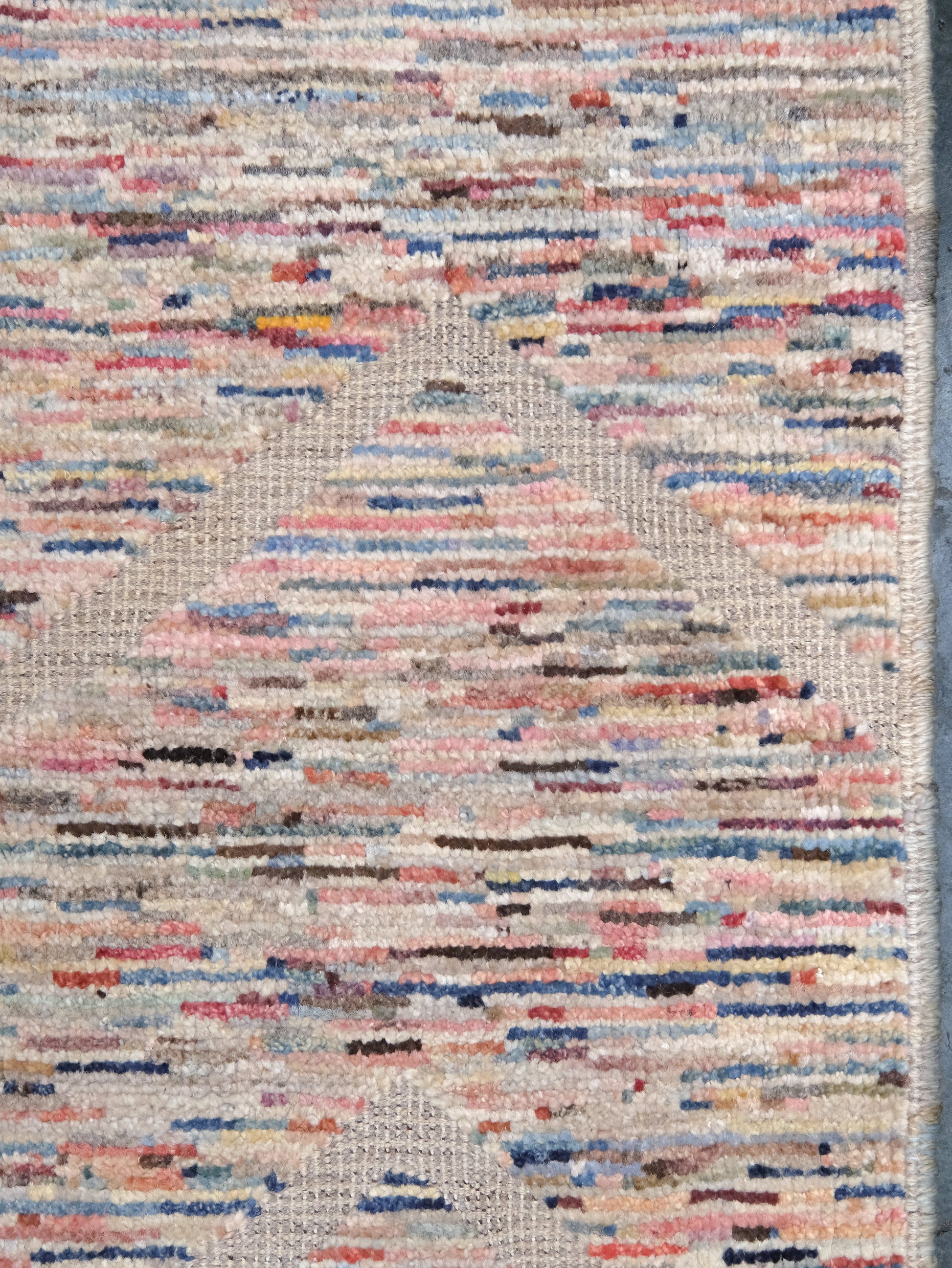 Painterly pastel  6x9 Turkish Tulu rug with raised geometric triangle pattern in ivory, oatmeal beige, blush pink, taupe, handmade textured wool from Indigo Rugs Burlingame Bay Area.
