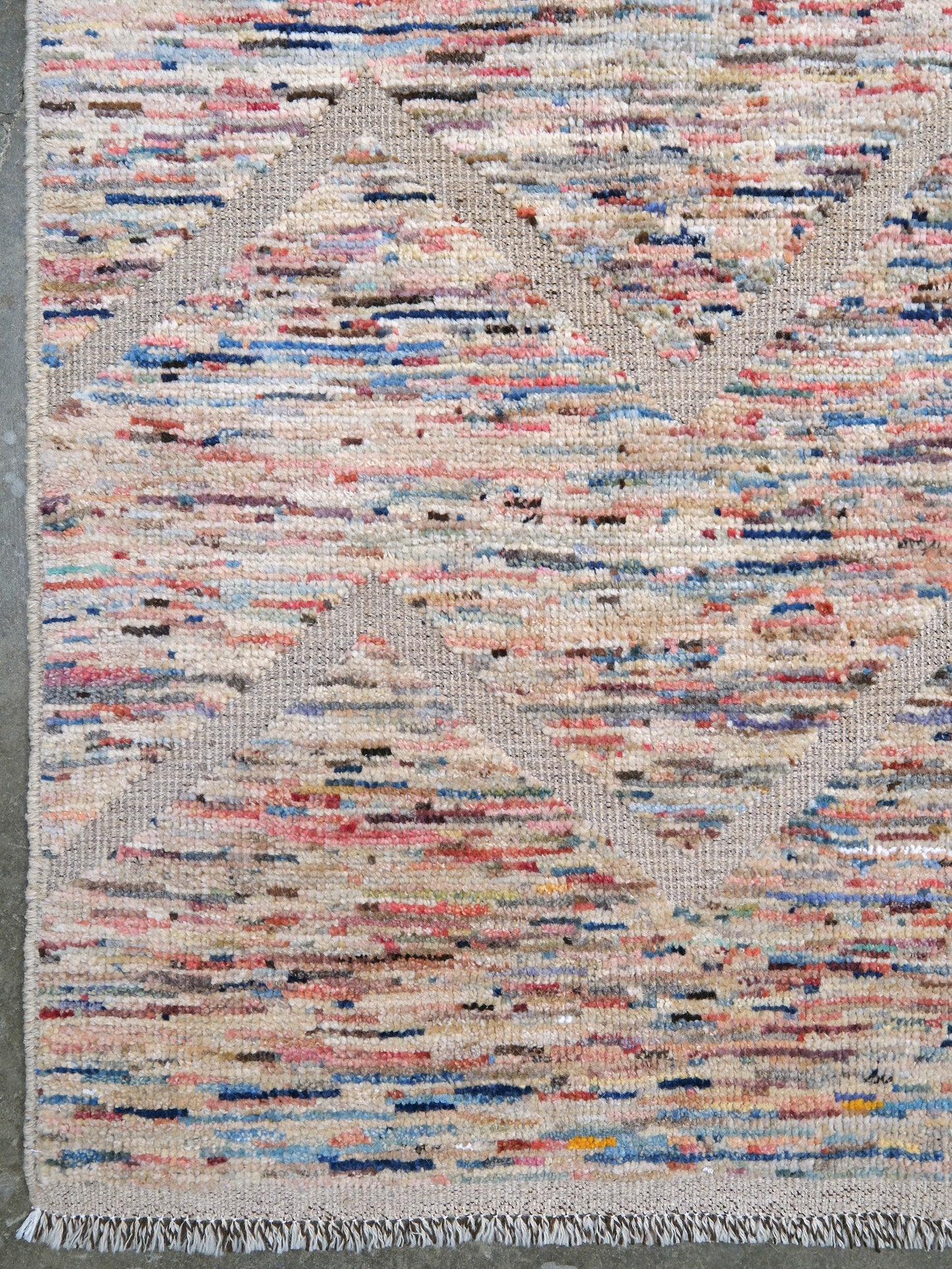 Painterly pastel  6x9 Turkish Tulu rug with raised geometric triangle pattern in ivory, oatmeal beige, blush pink, taupe, handmade textured wool from Indigo Rugs Burlingame Bay Area.