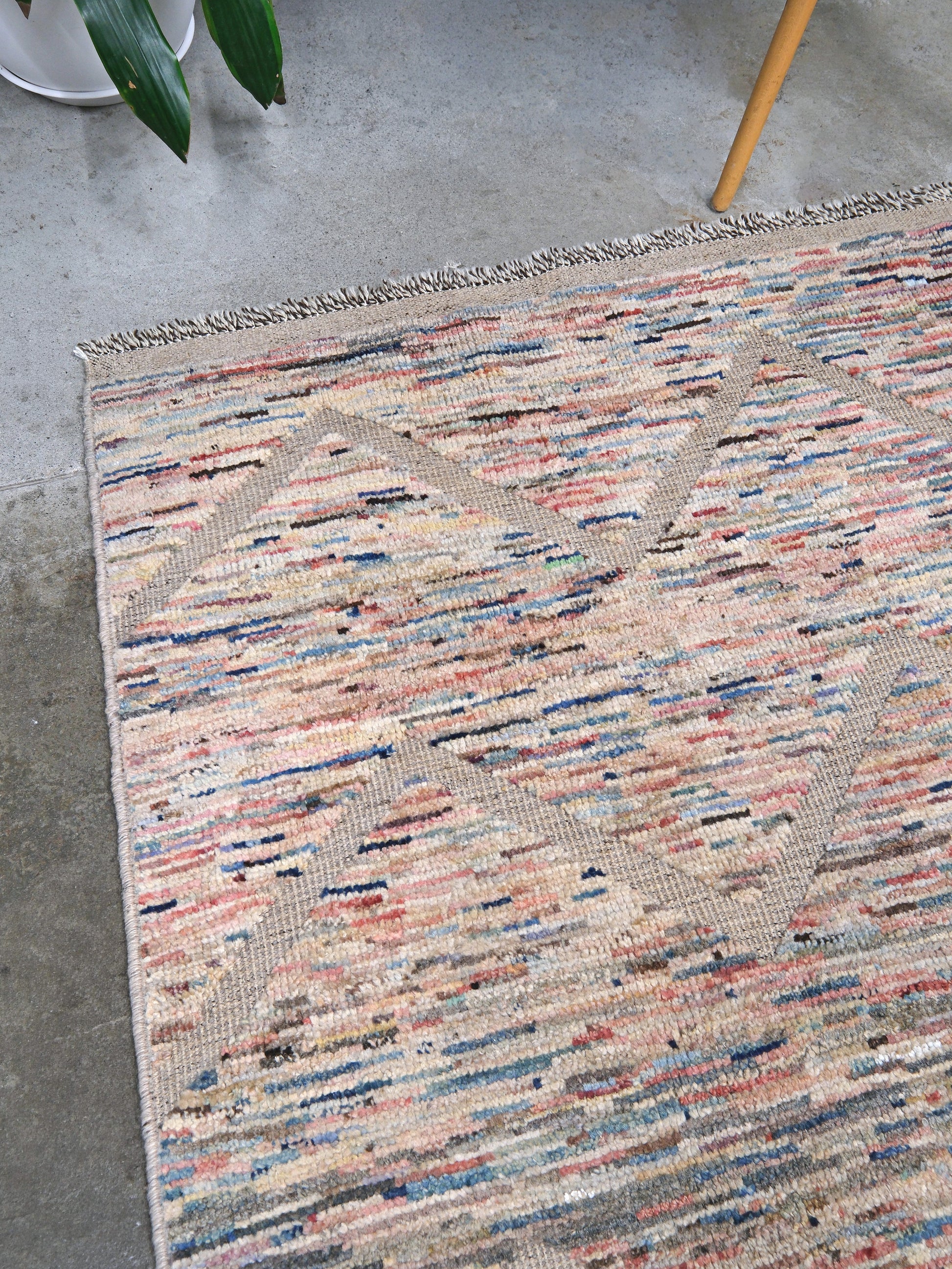 Painterly pastel  6x9 Turkish Tulu rug with raised geometric triangle pattern in ivory, oatmeal beige, blush pink, taupe, handmade textured wool from Indigo Rugs Burlingame Bay Area.