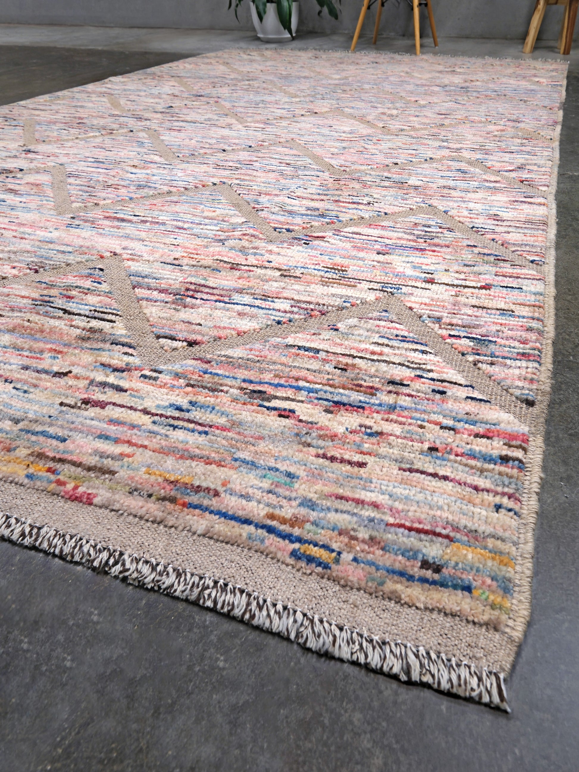 Painterly pastel  6x9 Turkish Tulu rug with raised geometric triangle pattern in ivory, oatmeal beige, blush pink, taupe, handmade textured wool from Indigo Rugs Burlingame Bay Area.