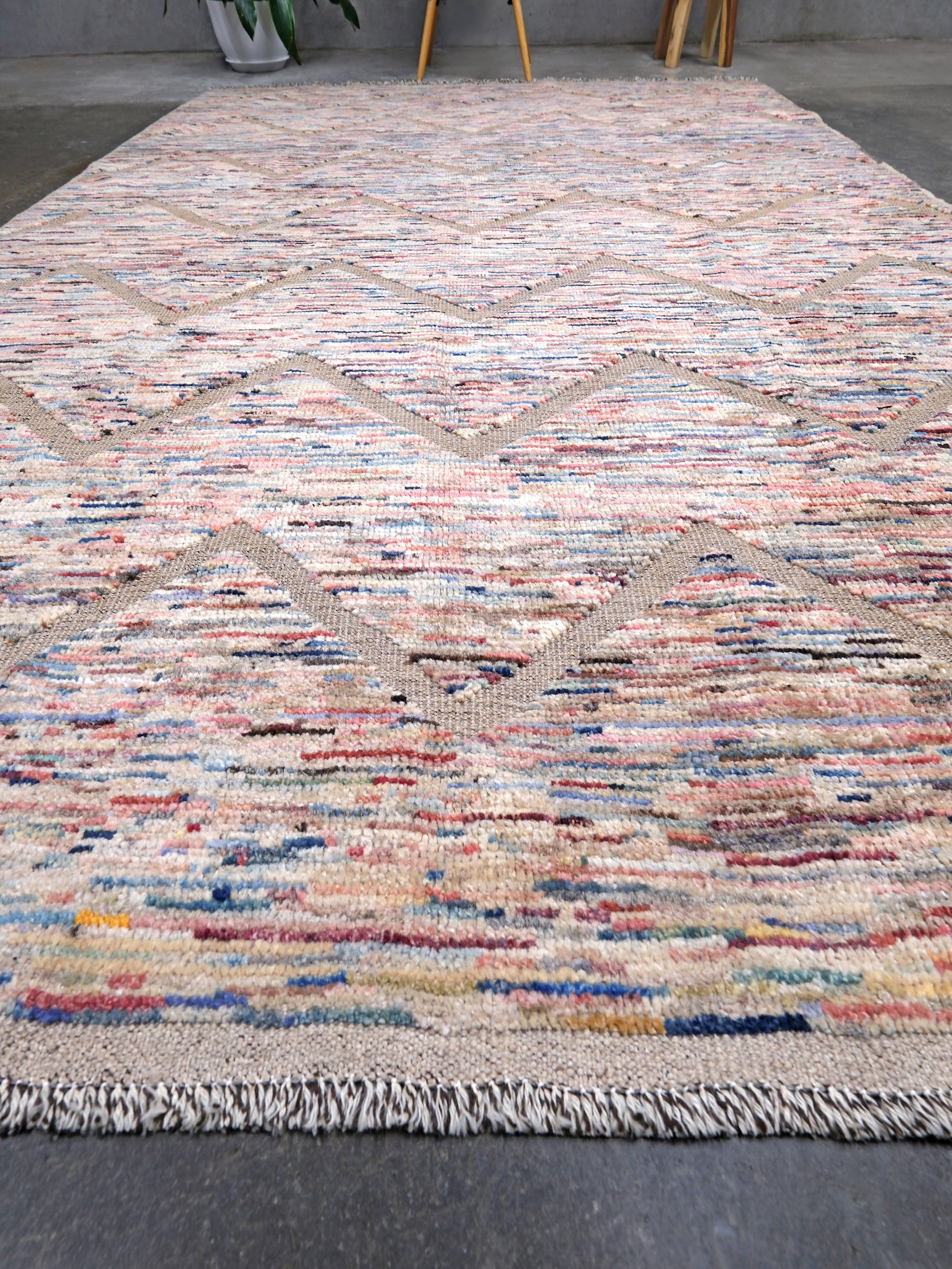 Painterly pastel  6x9 Turkish Tulu rug with raised geometric triangle pattern in ivory, oatmeal beige, blush pink, taupe, handmade textured wool from Indigo Rugs Burlingame Bay Area.