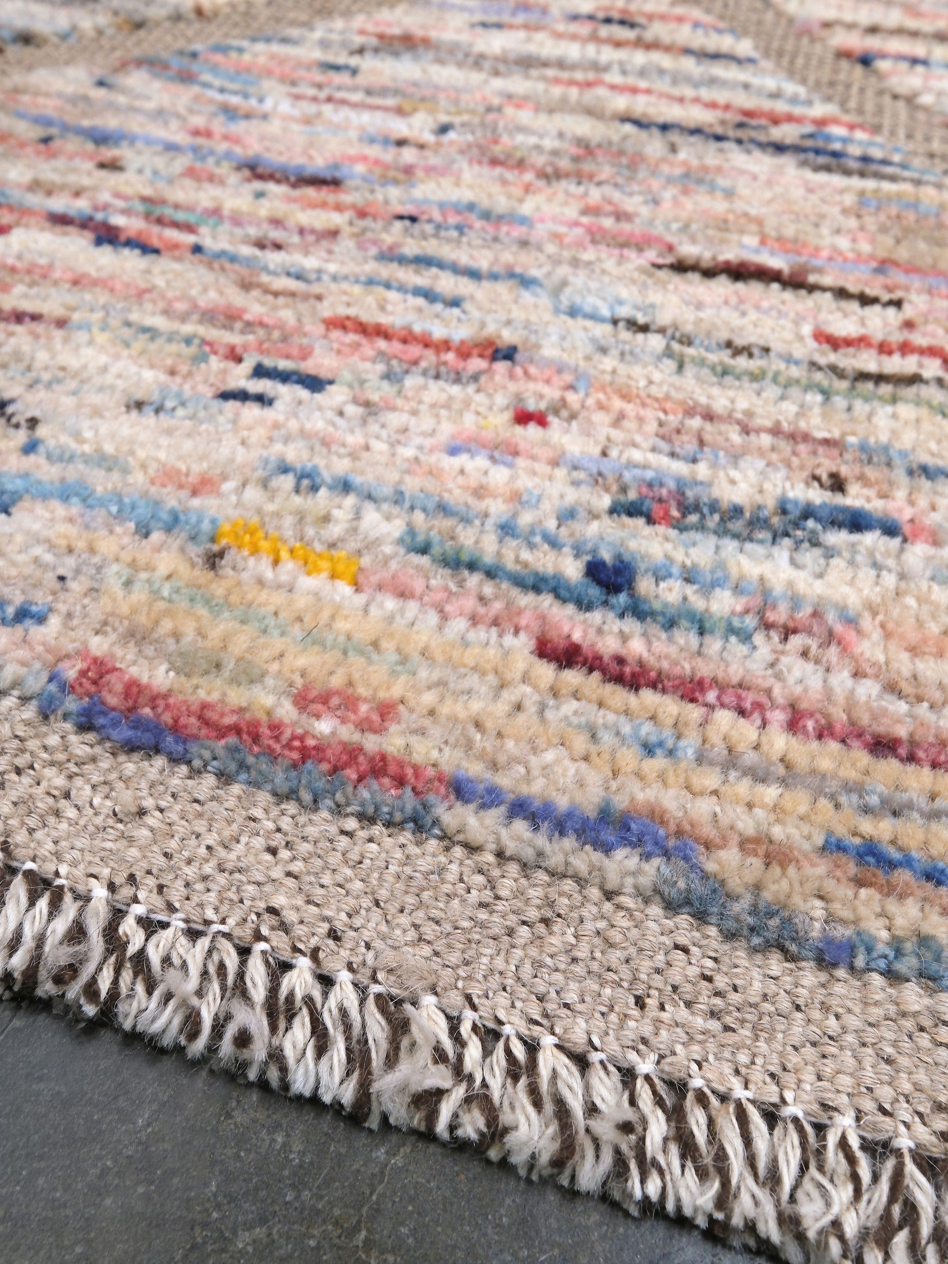 Painterly pastel  6x9 Turkish Tulu rug with raised geometric triangle pattern in ivory, oatmeal beige, blush pink, taupe, handmade textured wool from Indigo Rugs Burlingame Bay Area.