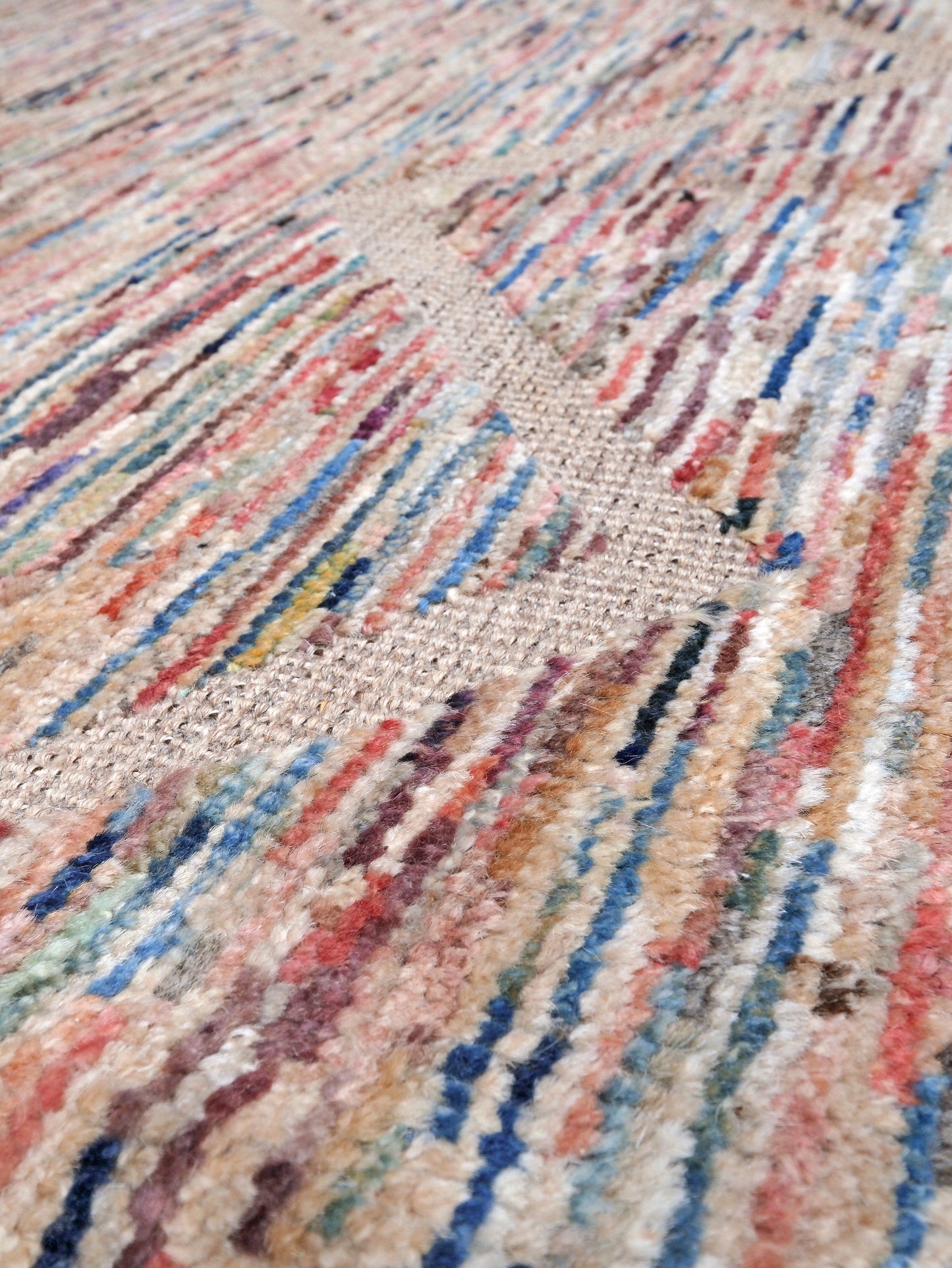 Painterly pastel  6x9 Turkish Tulu rug with raised geometric triangle pattern in ivory, oatmeal beige, blush pink, taupe, handmade textured wool from Indigo Rugs Burlingame Bay Area.