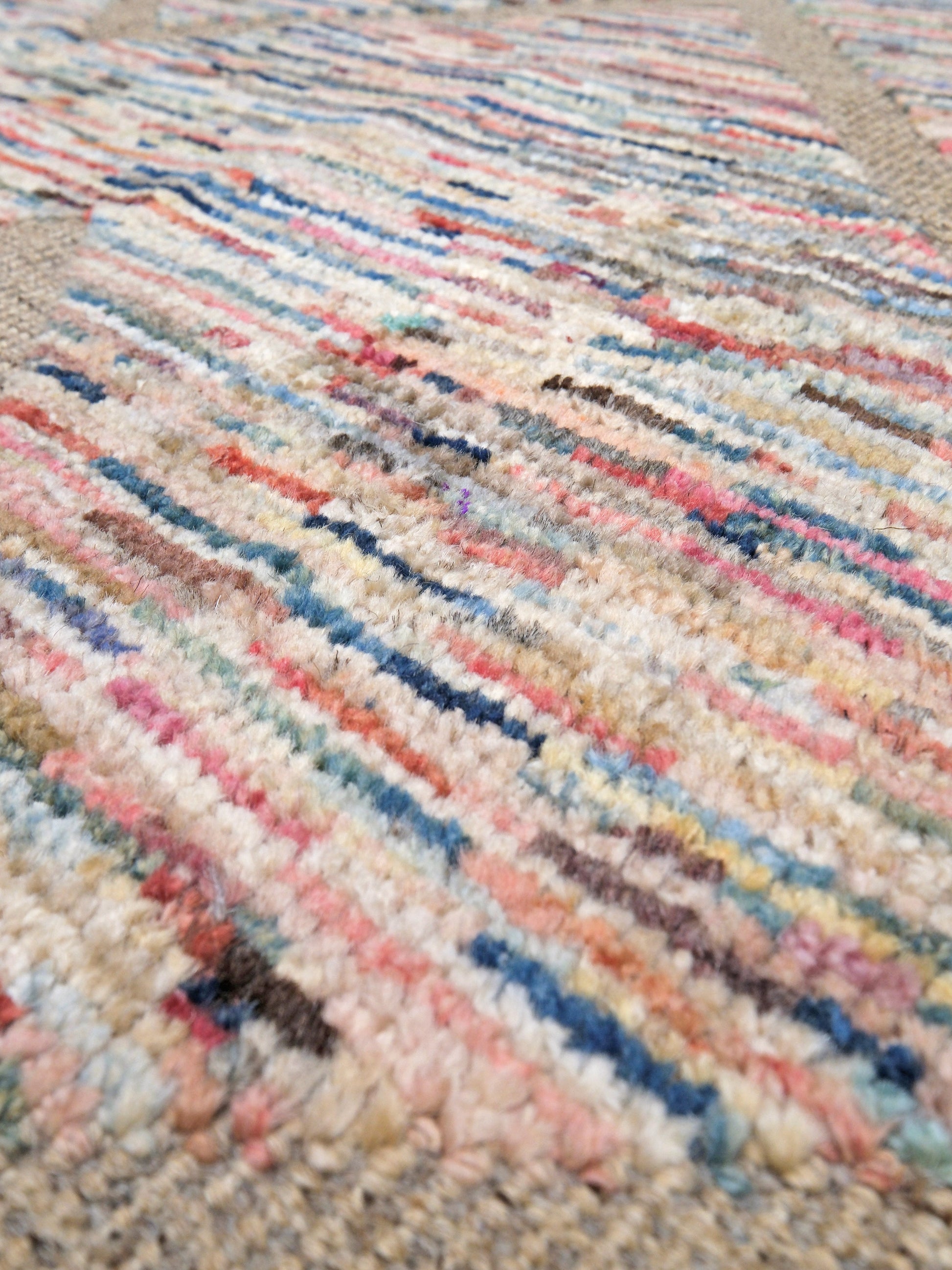 Painterly pastel  6x9 Turkish Tulu rug with raised geometric triangle pattern in ivory, oatmeal beige, blush pink, taupe, handmade textured wool from Indigo Rugs Burlingame Bay Area.