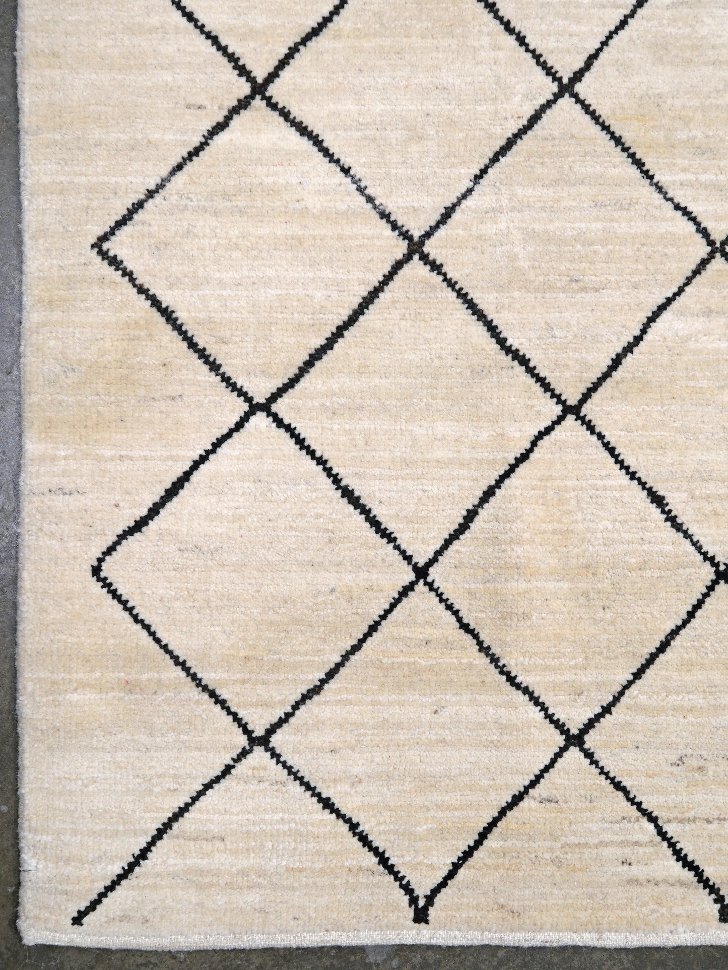Ivory natural beige minimalist Moroccan handmade wool rug with black diamond pattern, soft cream field and organic modern geometric design, 6x8 from Indigo Rugs Burlingame Bay Area.