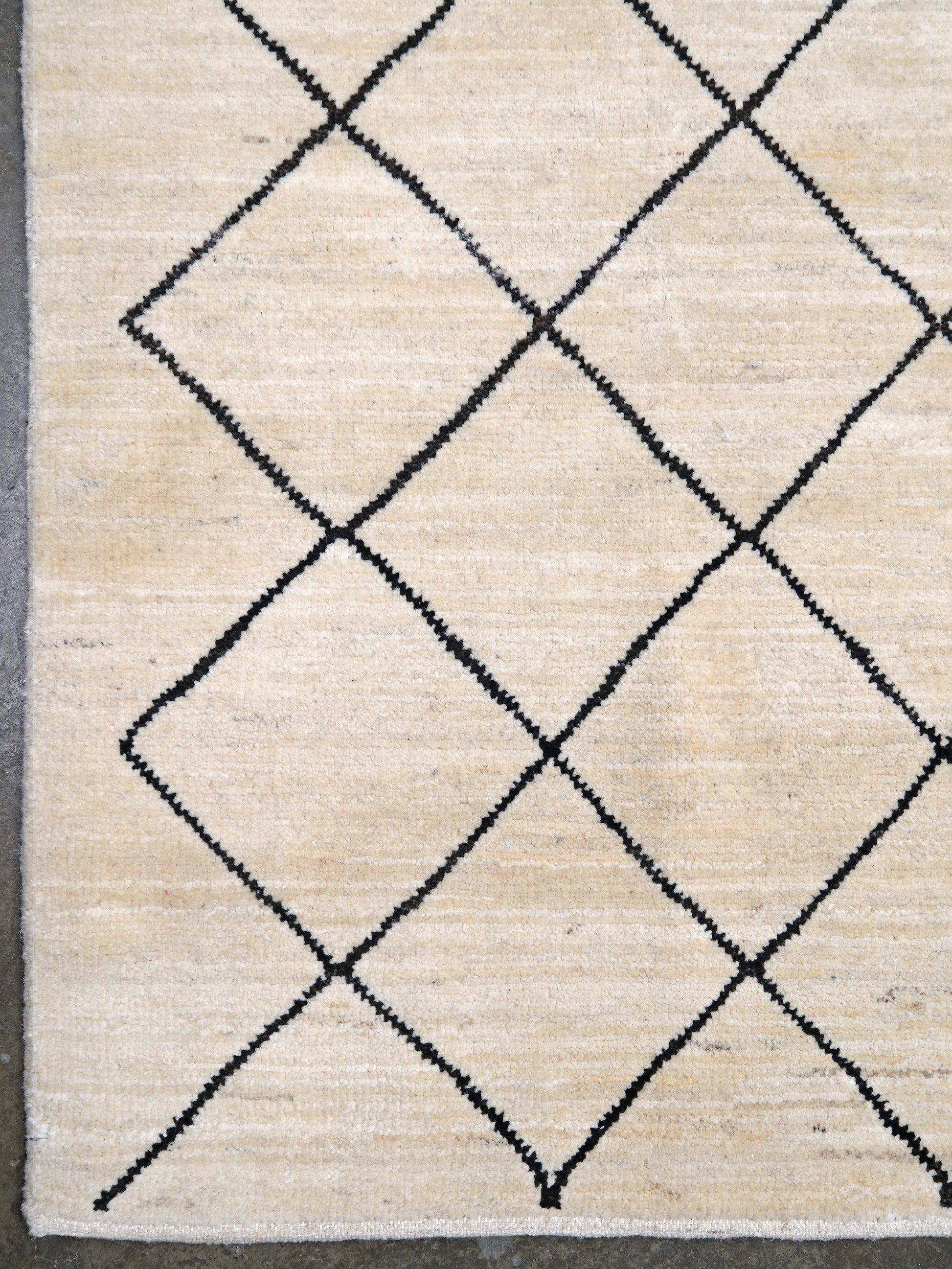 Ivory natural beige minimalist Moroccan handmade wool rug with black diamond pattern, soft cream field and organic modern geometric design, 6x8 from Indigo Rugs Burlingame Bay Area.