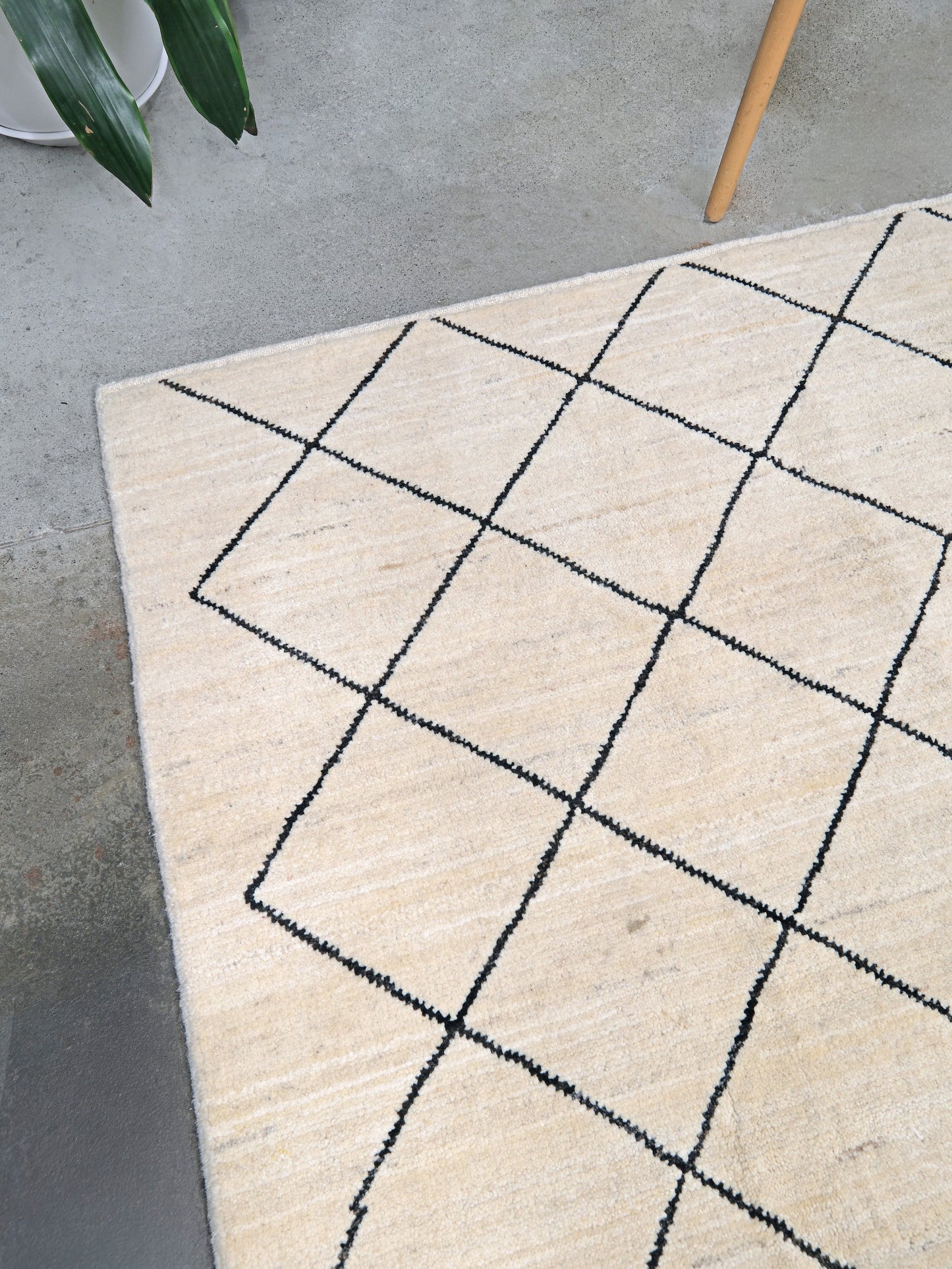 Ivory natural beige minimalist Moroccan handmade wool rug with black diamond pattern, soft cream field and organic modern geometric design, 6x8 from Indigo Rugs Burlingame Bay Area.