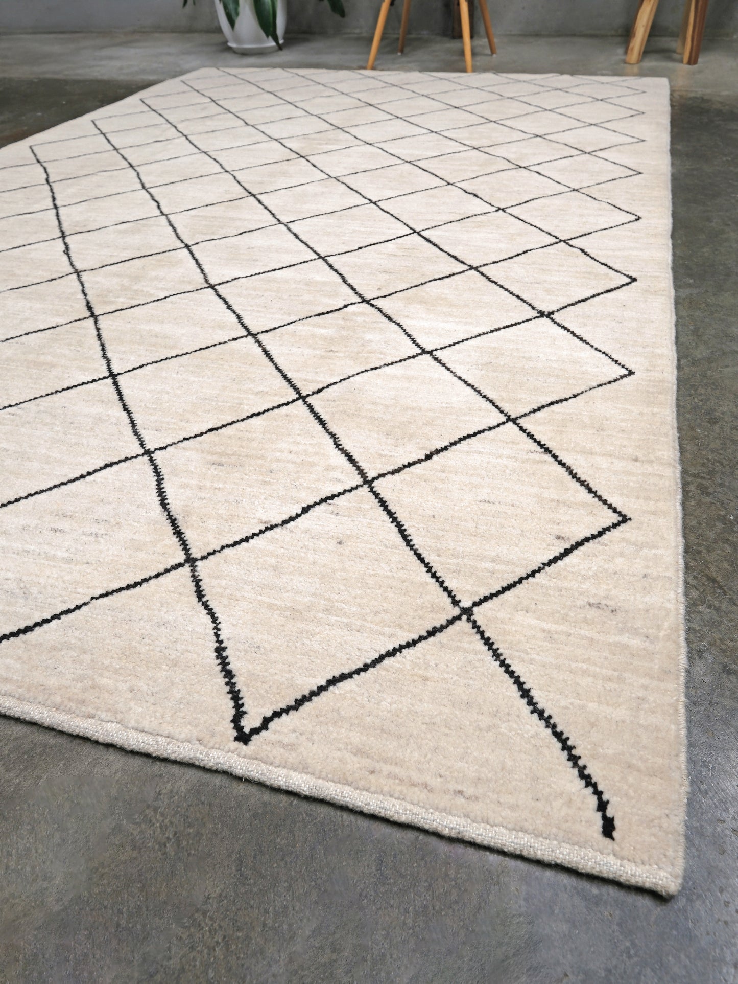 Ivory natural beige minimalist Moroccan handmade wool rug with black diamond pattern, soft cream field and organic modern geometric design, 6x8 from Indigo Rugs Burlingame Bay Area.