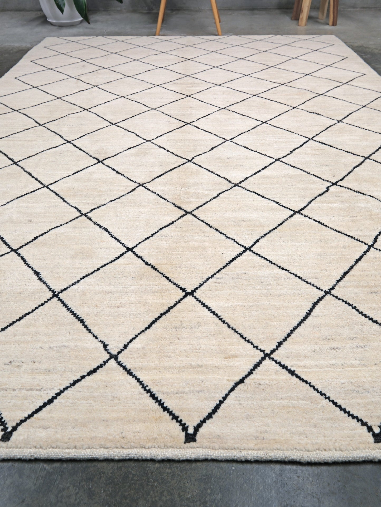 Ivory natural beige minimalist Moroccan handmade wool rug with black diamond pattern, soft cream field and organic modern geometric design, 6x8 from Indigo Rugs Burlingame Bay Area.