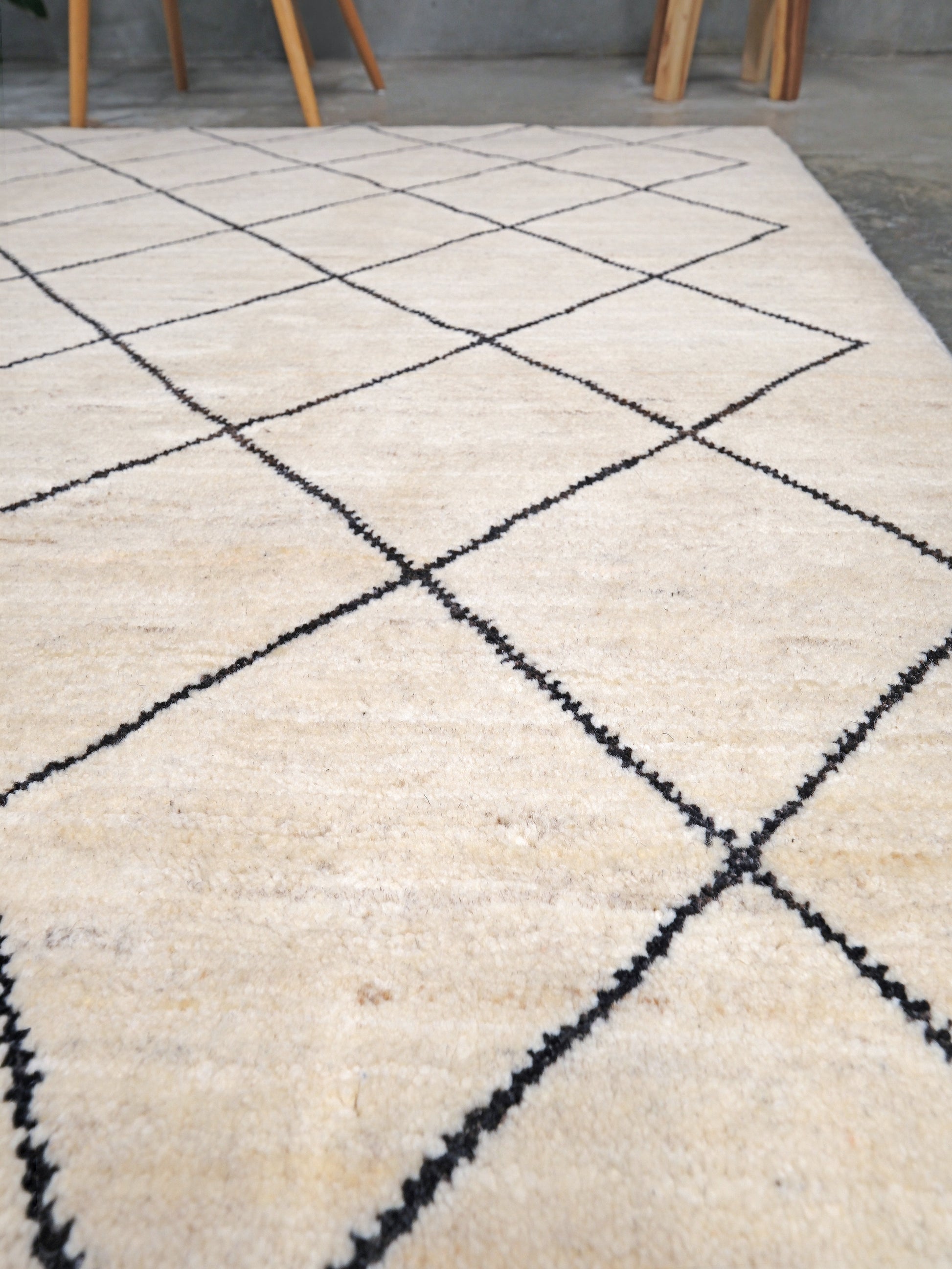 Ivory natural beige minimalist Moroccan handmade wool rug with black diamond pattern, soft cream field and organic modern geometric design, 6x8 from Indigo Rugs Burlingame Bay Area.