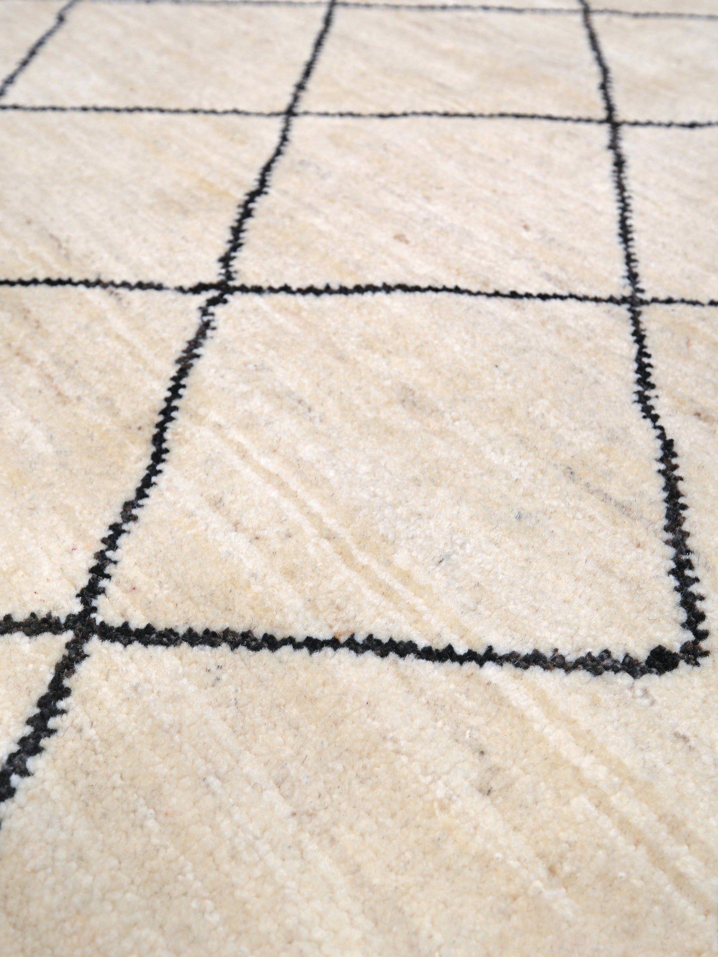 Ivory natural beige minimalist Moroccan handmade wool rug with black diamond pattern, soft cream field and organic modern geometric design, 6x8 from Indigo Rugs Burlingame Bay Area.