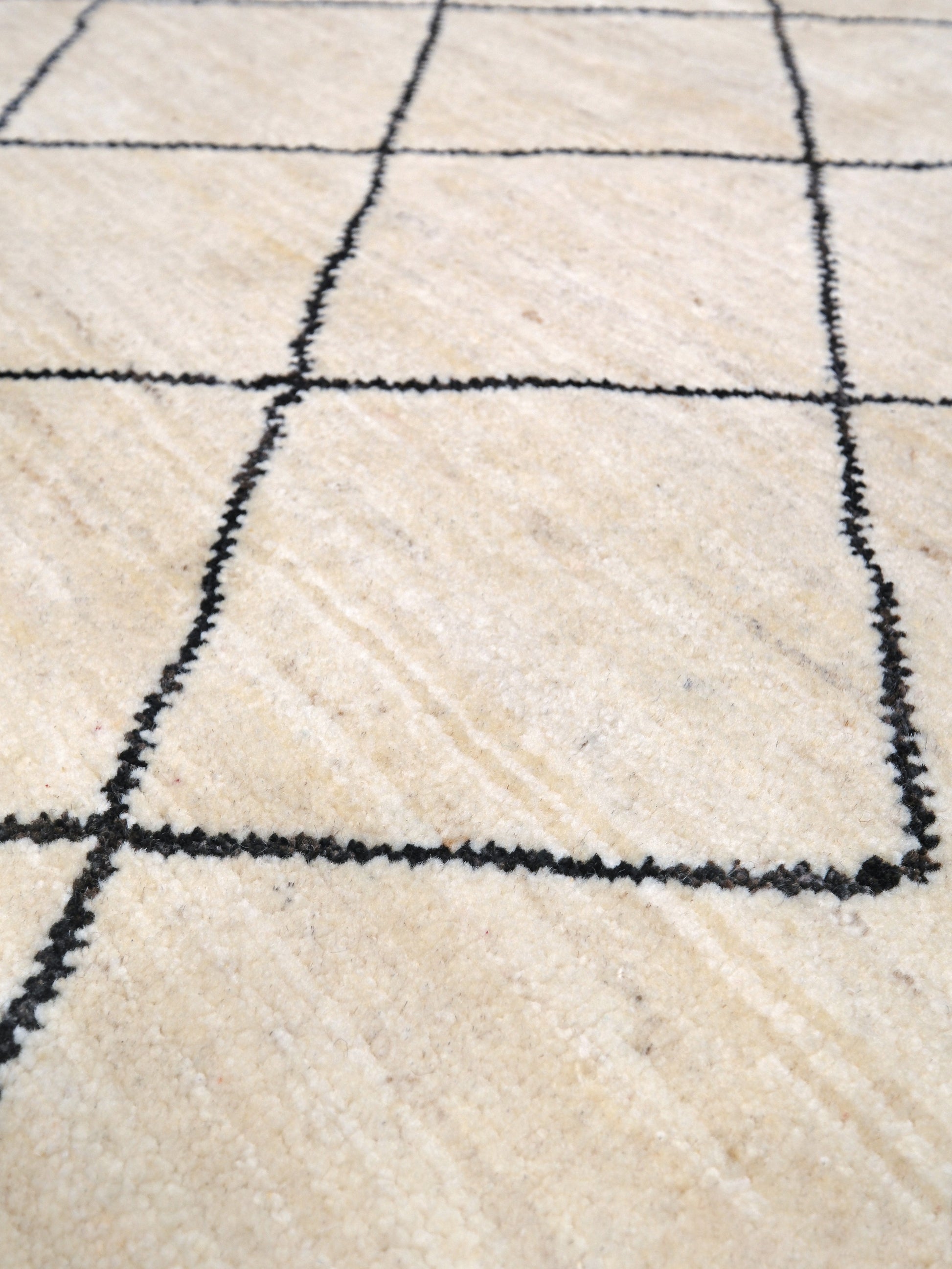 Ivory natural beige minimalist Moroccan handmade wool rug with black diamond pattern, soft cream field and organic modern geometric design, 6x8 from Indigo Rugs Burlingame Bay Area.