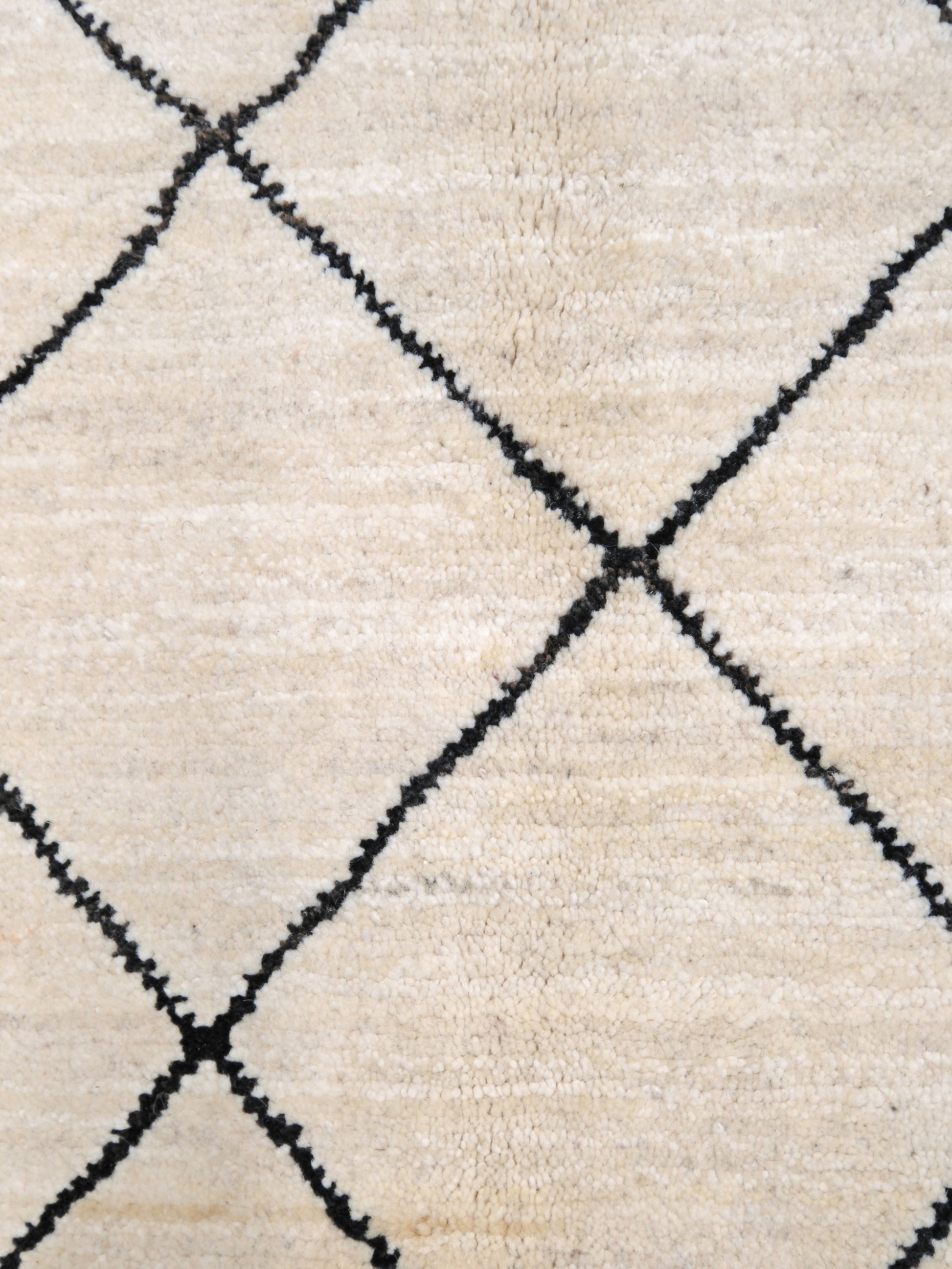 Ivory natural beige minimalist Moroccan handmade wool rug with black diamond pattern, soft cream field and organic modern geometric design, 6x8 from Indigo Rugs Burlingame Bay Area.