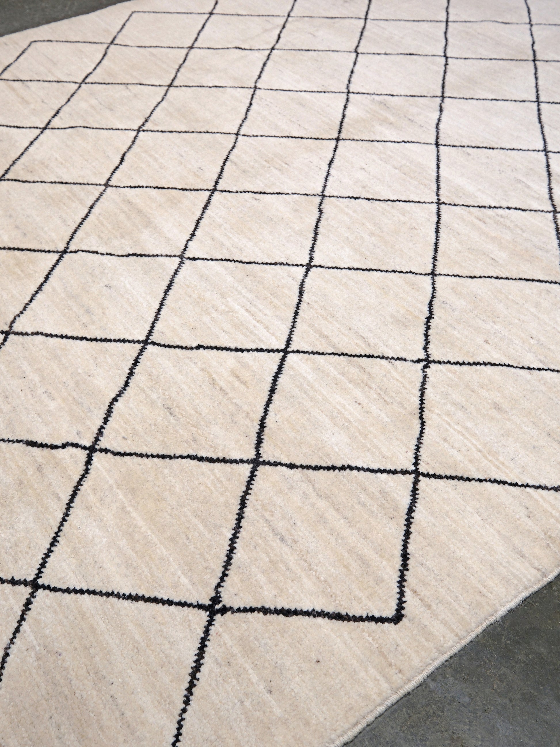 Ivory natural beige minimalist Moroccan handmade wool rug with black diamond pattern, soft cream field and organic modern geometric design, 6x8 from Indigo Rugs Burlingame Bay Area.