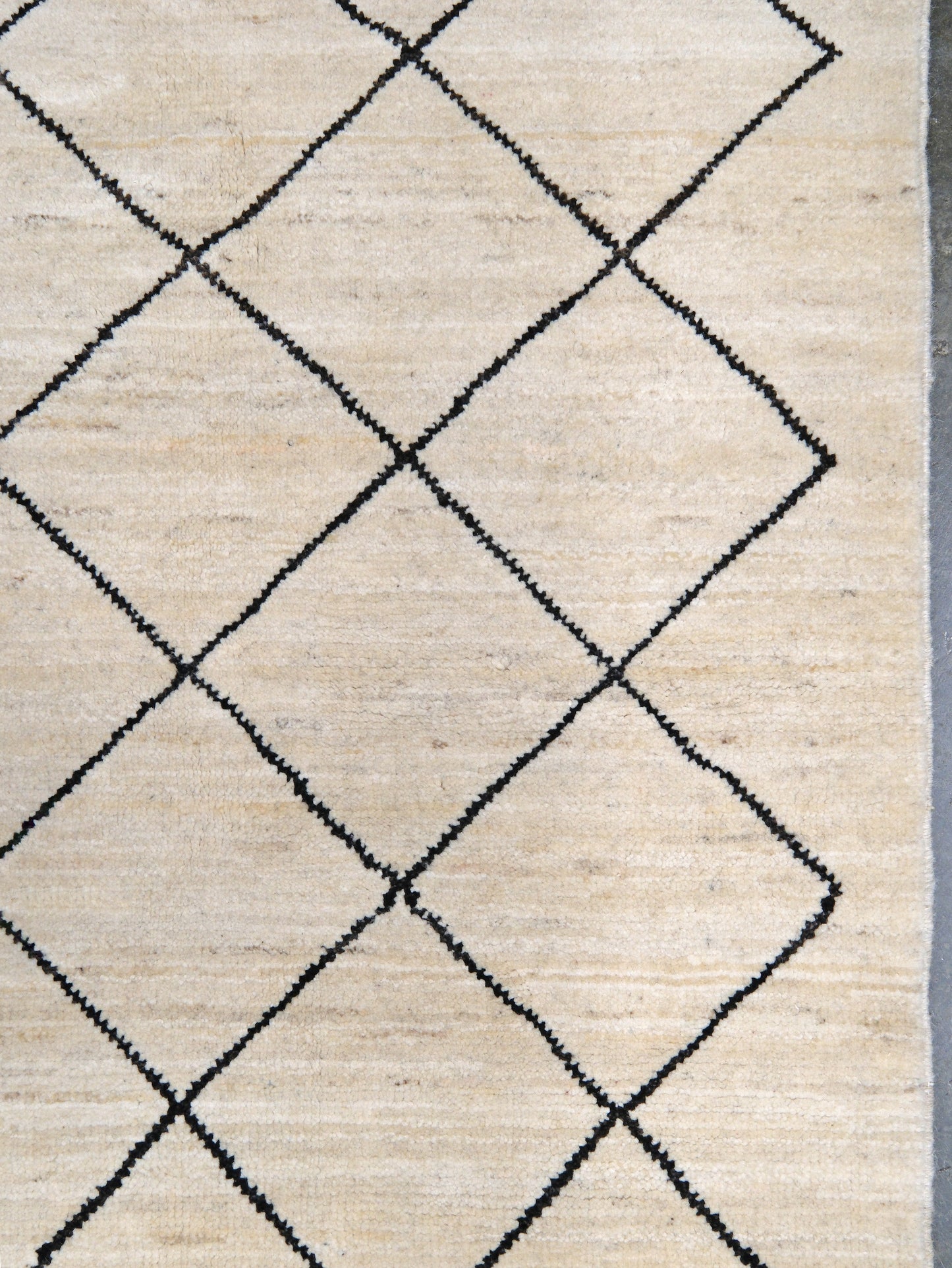Ivory natural beige minimalist Moroccan handmade wool rug with black diamond pattern, soft cream field and organic modern geometric design, 6x8 from Indigo Rugs Burlingame Bay Area.