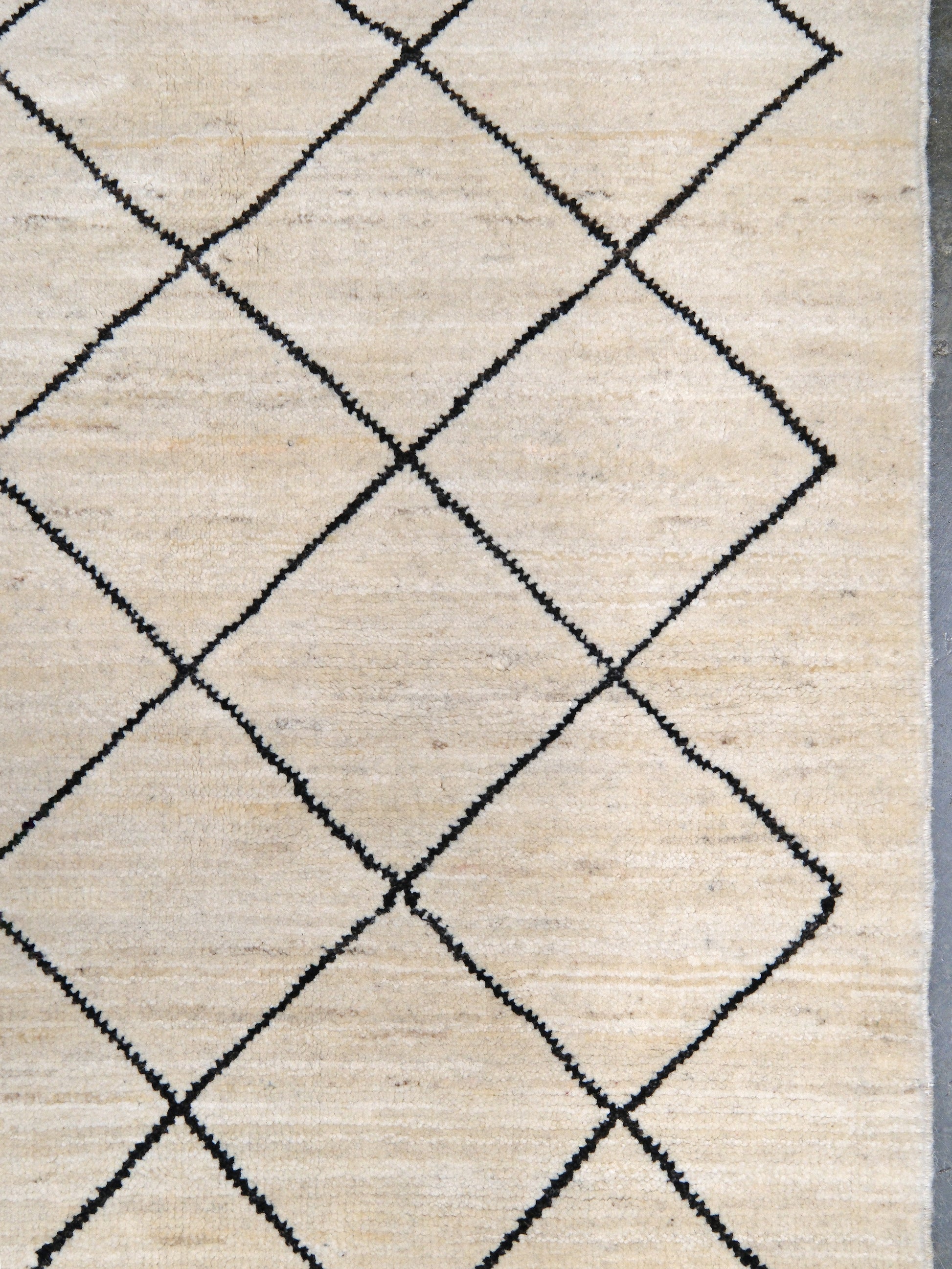 Ivory natural beige minimalist Moroccan handmade wool rug with black diamond pattern, soft cream field and organic modern geometric design, 6x8 from Indigo Rugs Burlingame Bay Area.