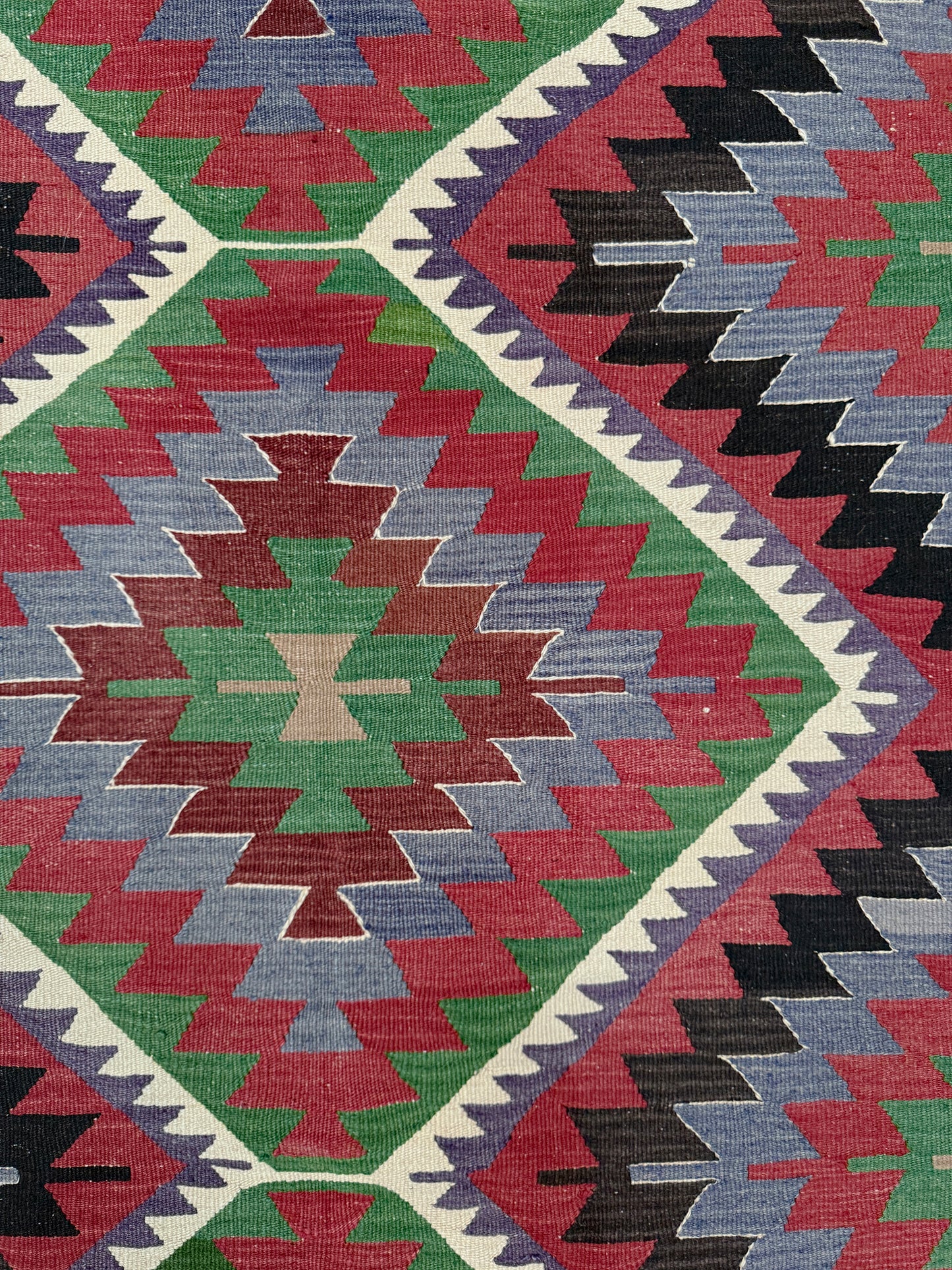 Colorful geometric patterned fabric with a diamond shape. Vintage Esme Turkish kilim featuring navajo style geometric design, handwoven wool flatweave rug 6x9