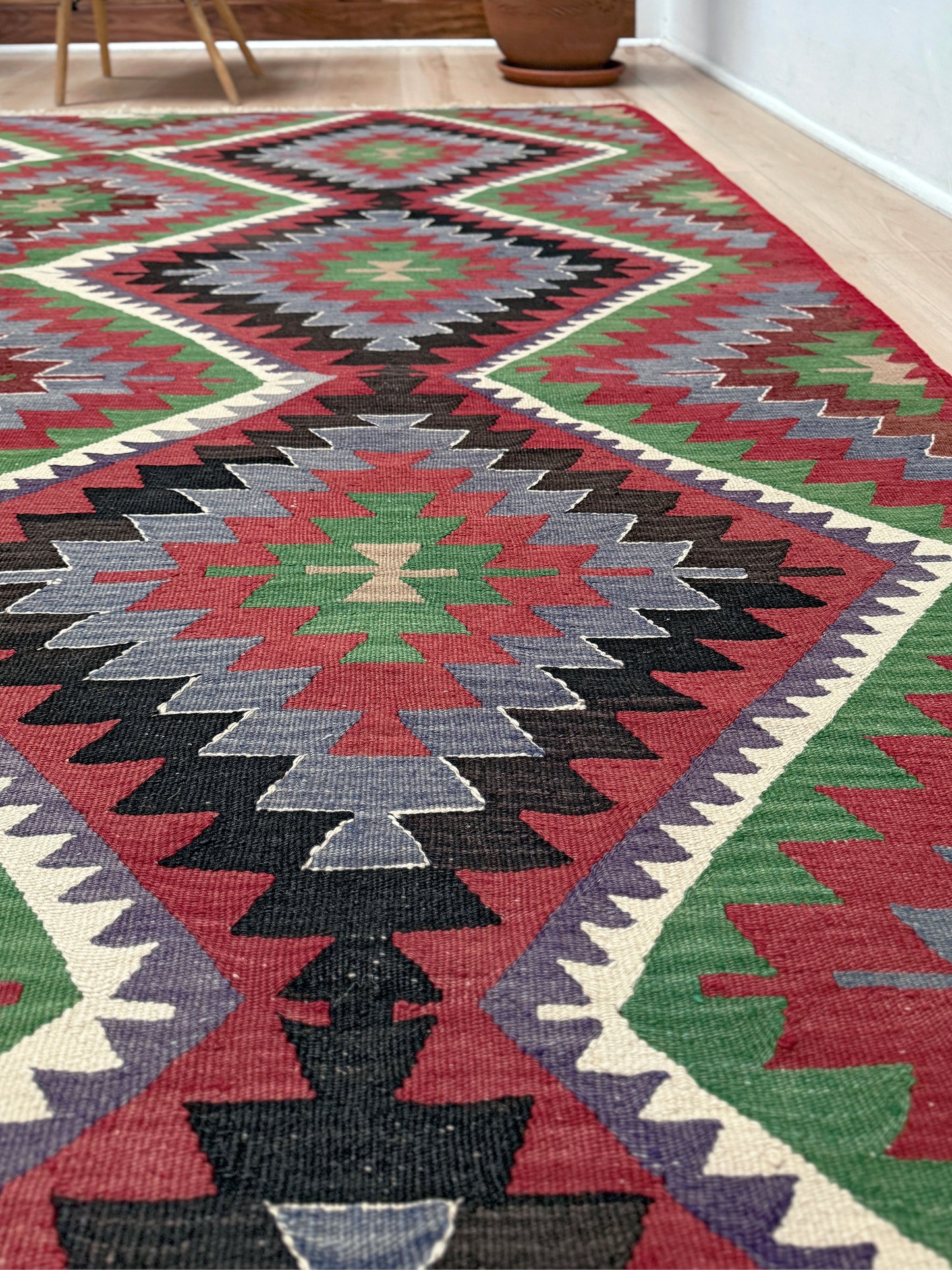 Vintage Esme Turkish kilim featuring navajo style geometric design, handwoven wool flatweave rug 6x9