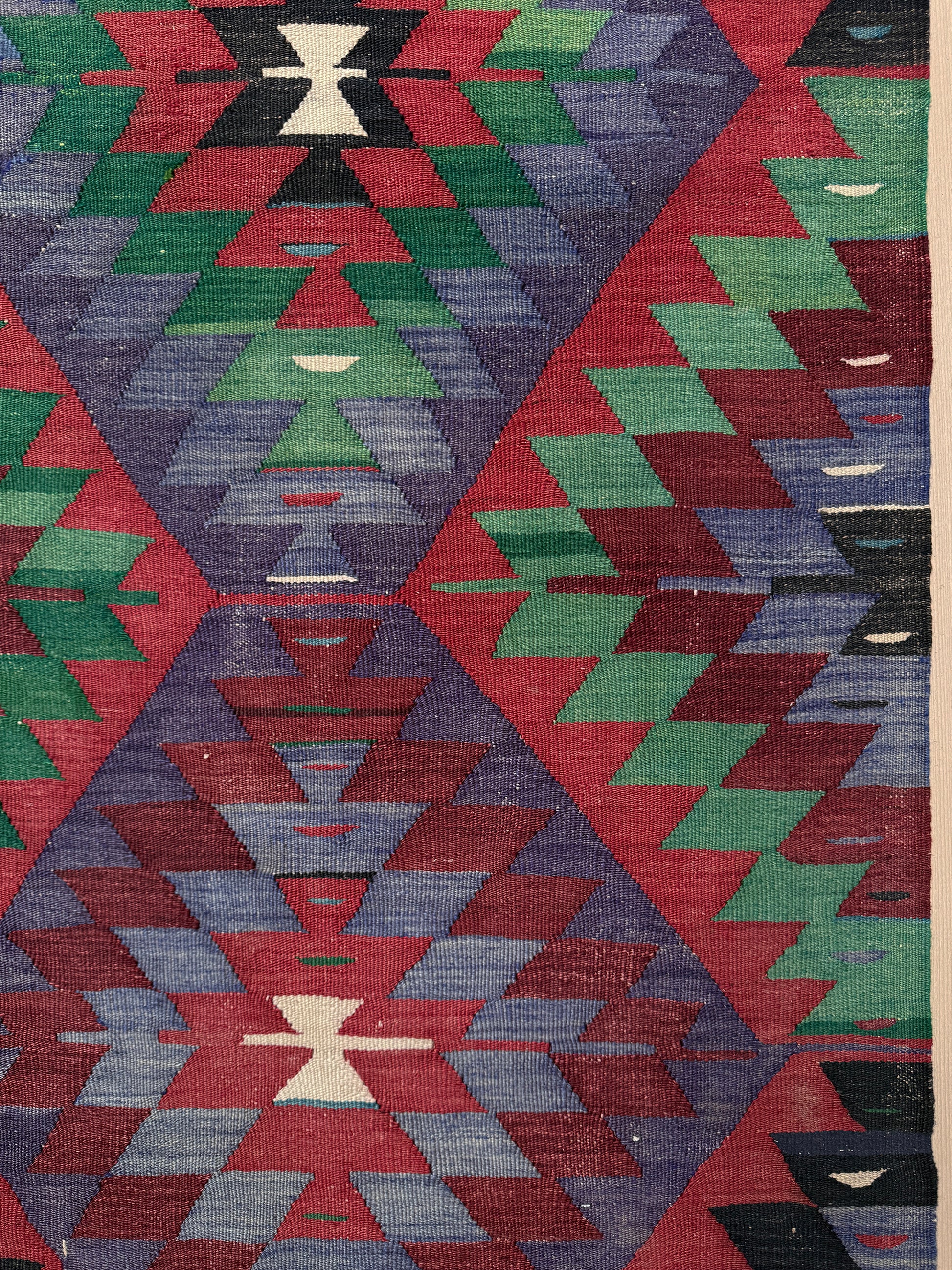 Geometric patterned rug with red, green, blue, and black colors. Vintage Esme Turkish tribal kilim rug featuring geometric design in raspberry red, blue violet, emerald green, handmade 6x10 perfect for boho style 