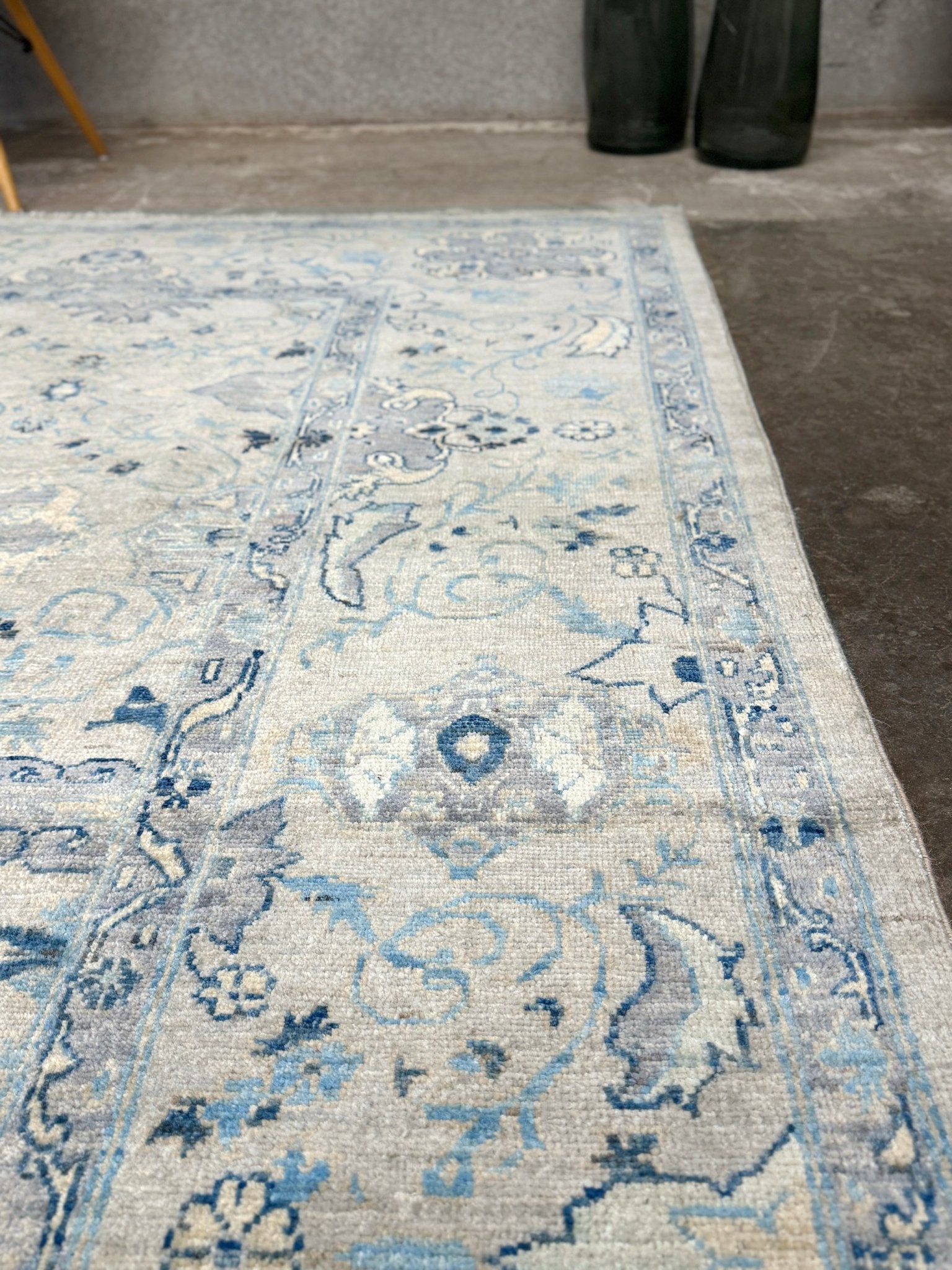 Neutral transitional handmade 8x10 decorative rug with muted gray, ivory, and layered blue tones. Soft Sultanabad-inspired floral motifs, perfect for living rooms, dining spaces, or bedrooms. Contemporary yet timeless, from a rug shop in Burlingame, San Francisco Bay Area, CA with free shipping.